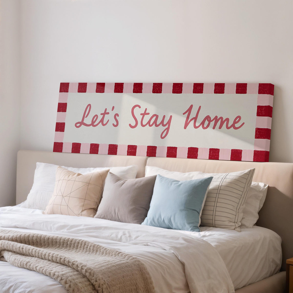 Let's stay home sign with a red checked border wide panoramic canvas print above a bed in a bedroom