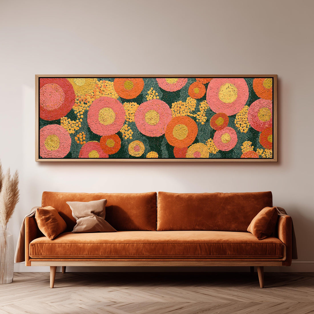 Pink circle blooms long horizontal canvas print above a sofa in a living room