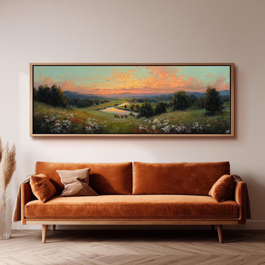 a large landscape painting hanging on a wall above a brown sofa with two pillows.