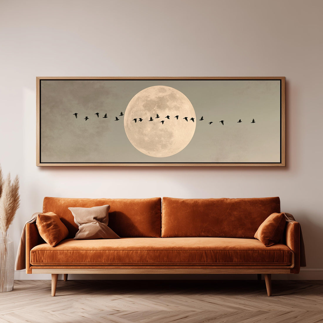 Geese crossing a full moon on grey long horizontal canvas print above a sofa in a living room