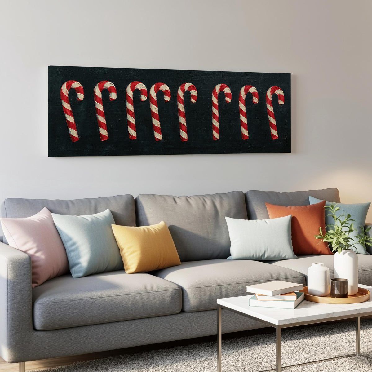 Row of candy canes on black panoramic canvas print above a grey sofa in a living room