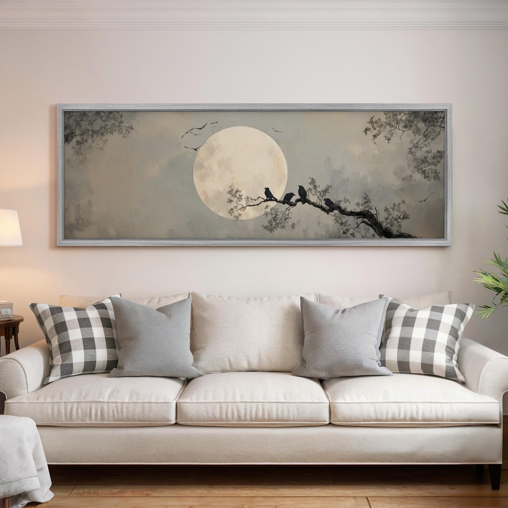 a large framed painting of a night scene with a full moon, silhouetted trees, and birds perched on branches.