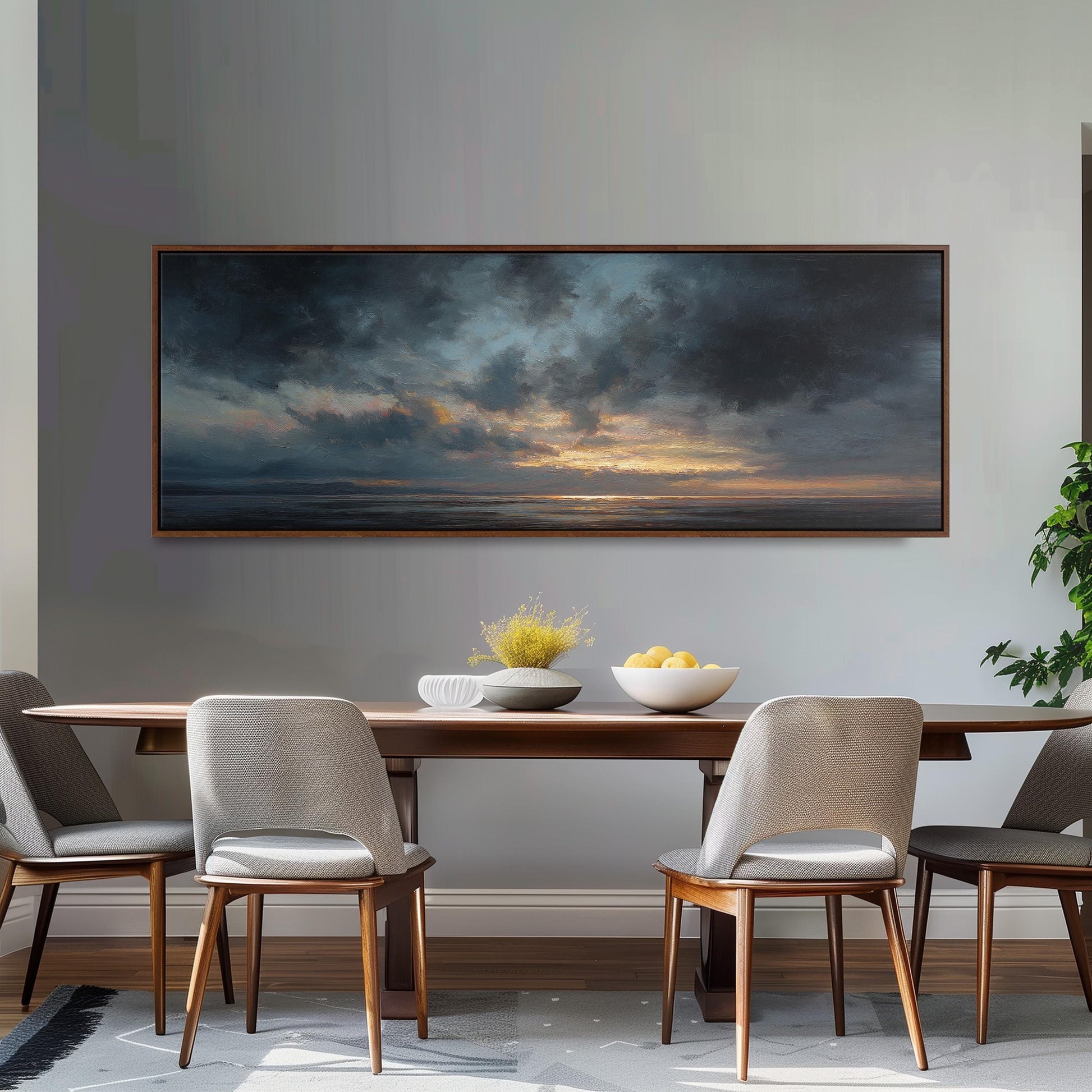 a dining room with a large painting of a cloudy sky hanging on the wall above a wooden dining table with four chairs. The table is set with a bowl of fruit and a vase of flowers, creating a cozy and inviting atmosphere.