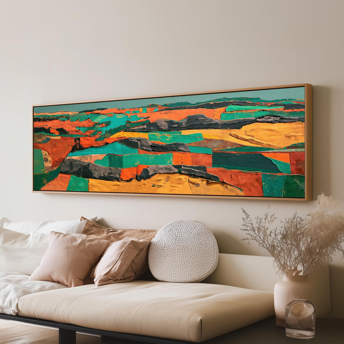 Abstract patchwork terrain in orange and teal panoramic canvas print above a sofa in a living room