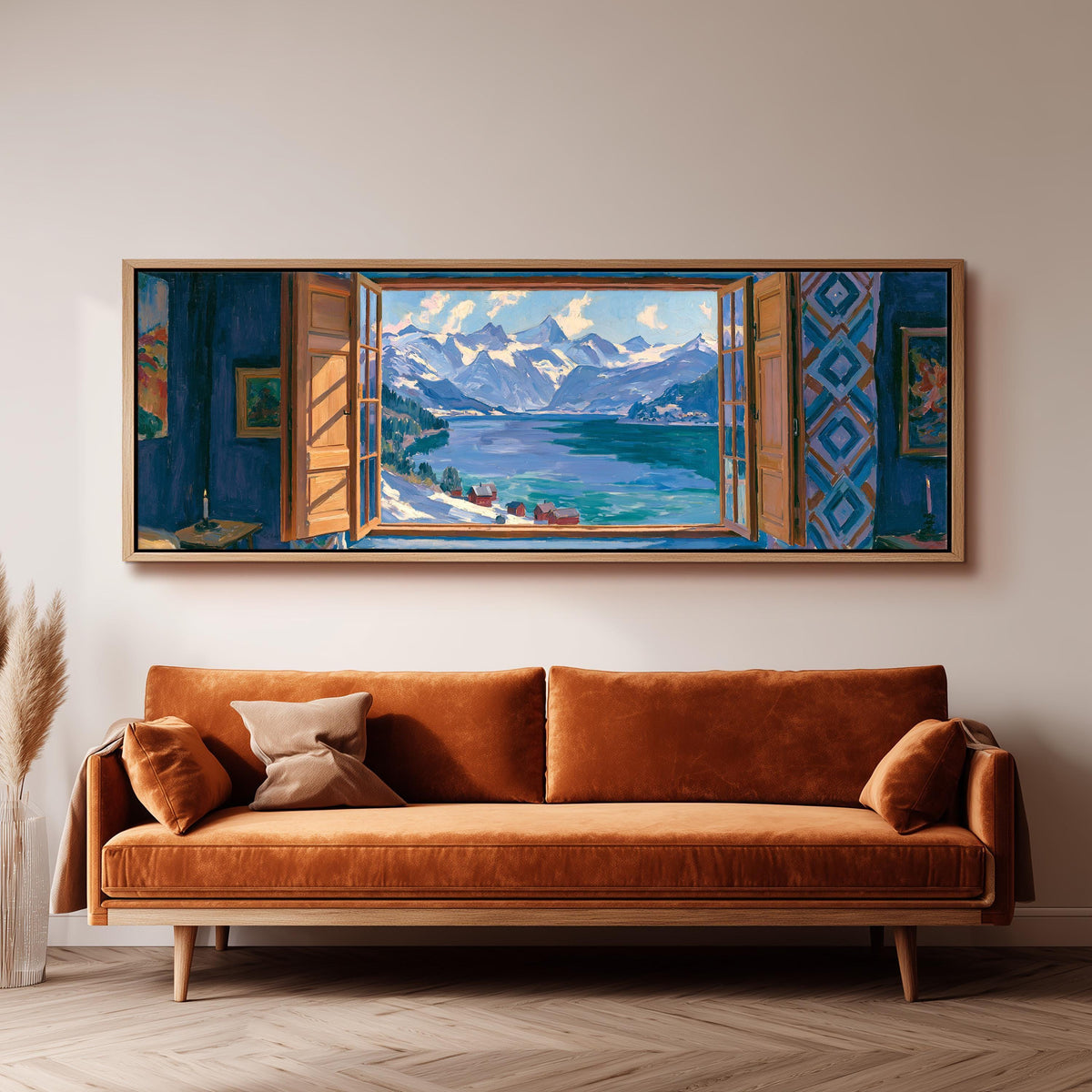 Snowy alpine lake seen through a window panoramic canvas print above a sofa in a living room