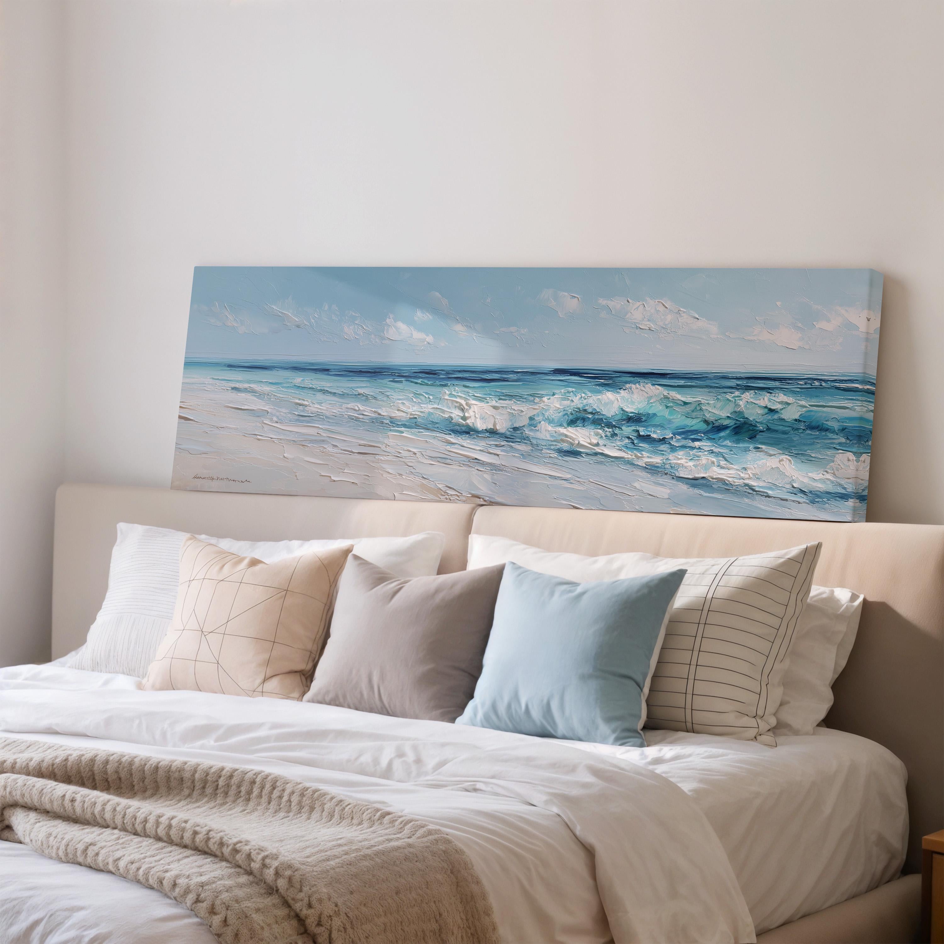 a large painting of a beach scene hanging on a wall above a bed with white bedding and pillows.