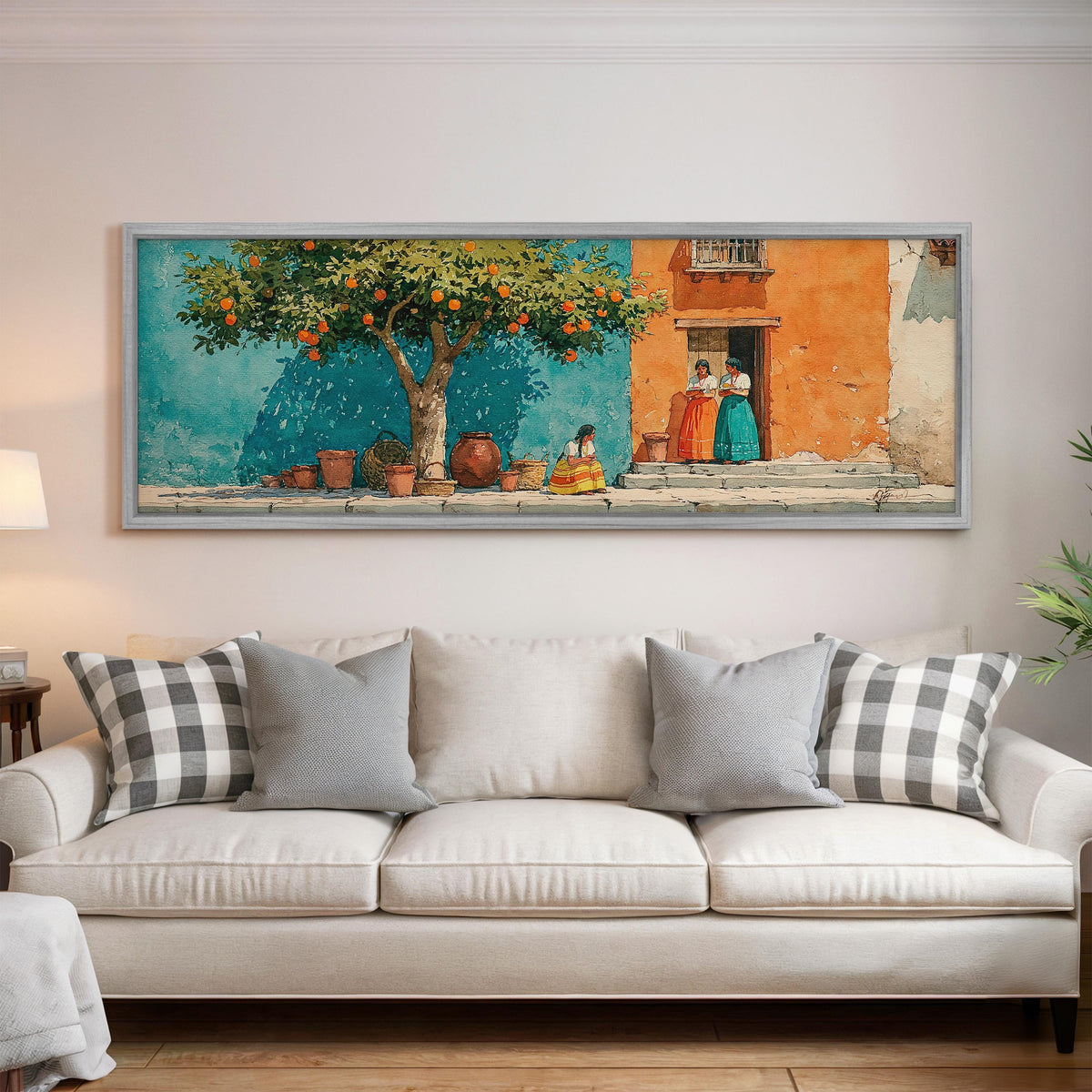 Orange tree on a colorful village street panoramic canvas print above a white sofa in a bright living room