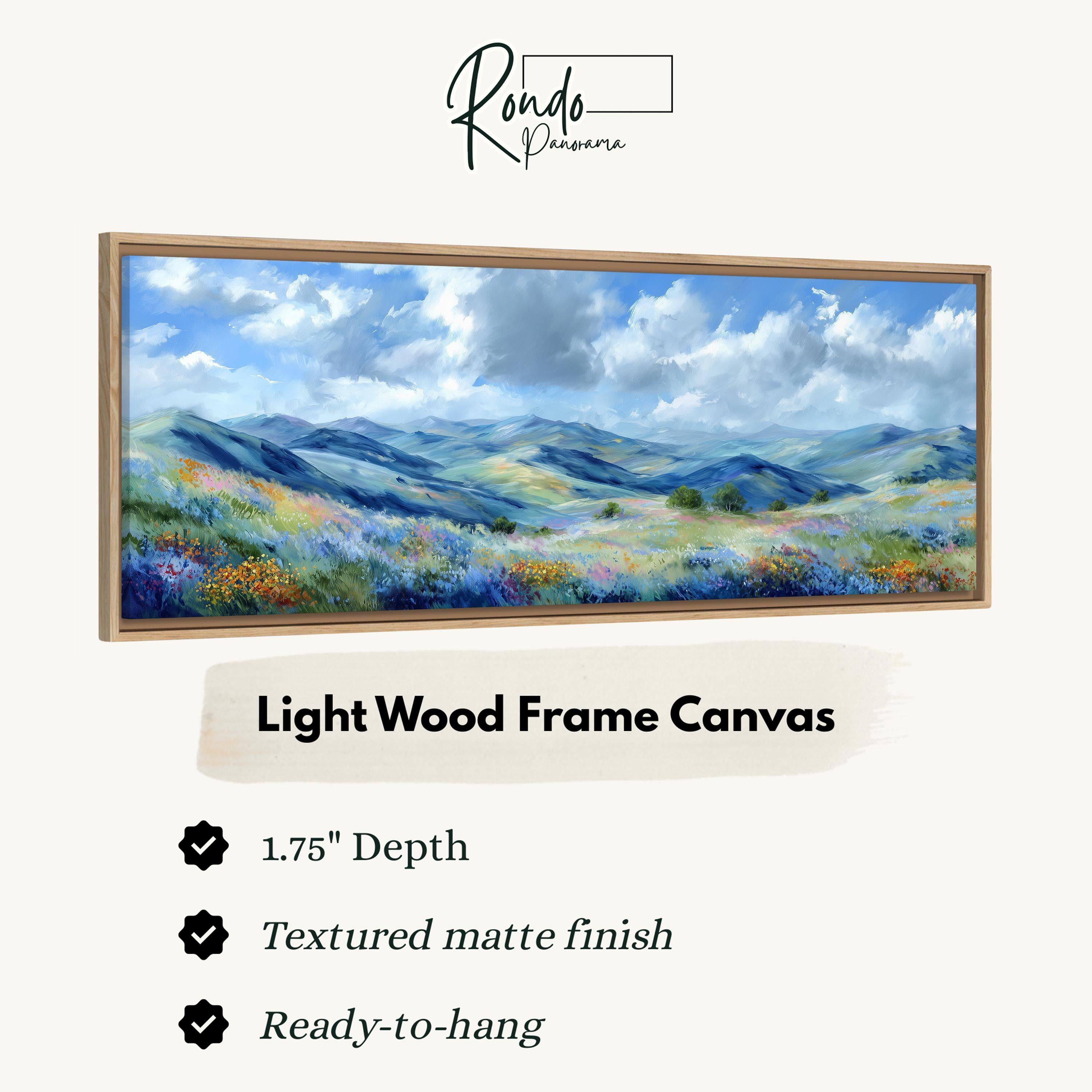 The image is a light wood frame canvas depicting a landscape with mountains, flowers, and a cloudy sky.