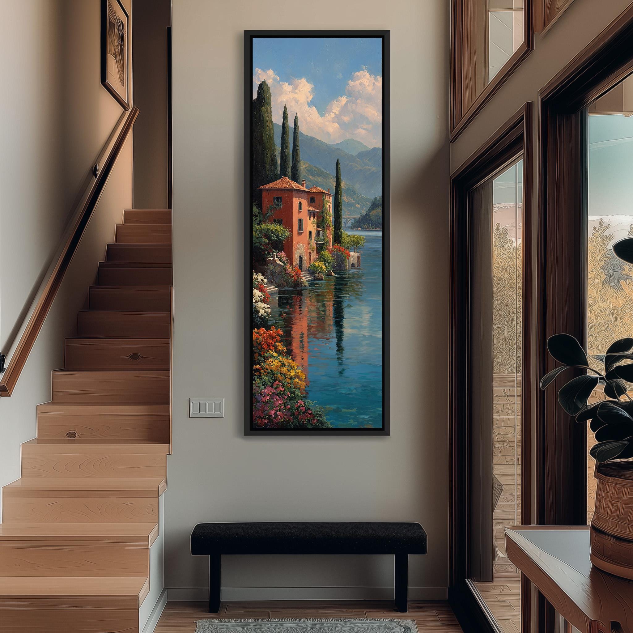 a large painting of a picturesque Italian landscape hanging on the wall of a hallway. The painting depicts a serene scene with a river, mountains, and a charming red-roofed building, surrounded by colorful flowers. The hallway is well-lit, with a wooden staircase leading up to the painting, and a bench placed in front of it. The overall atmosphere of the image is warm and inviting, with the painting serving as a focal point in the space.