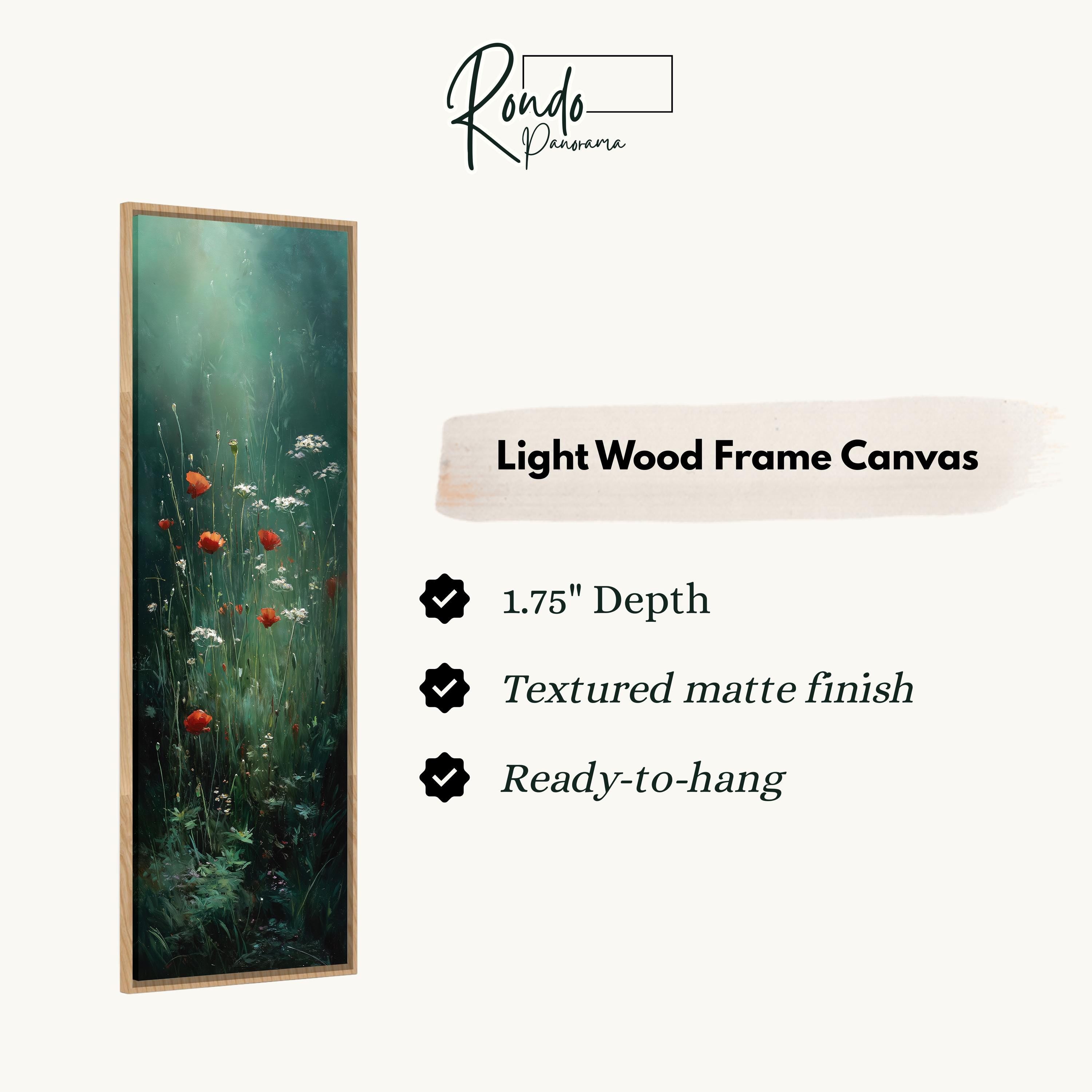 The image is a light wood frame canvas depicting a lush green field with red flowers.