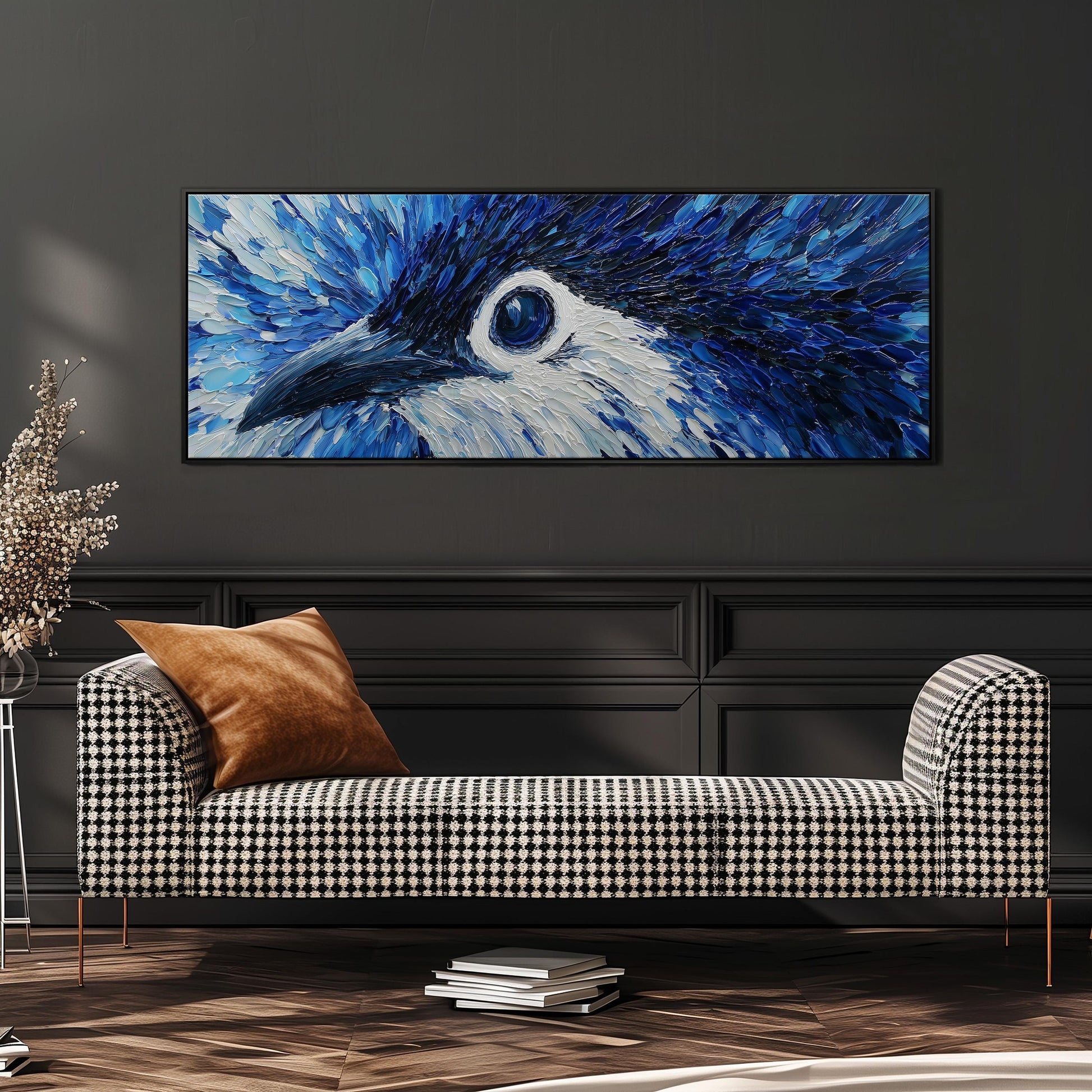 a large, colorful painting of a blue bird's eye on a wall, with a black and white checkered sofa in the foreground.
