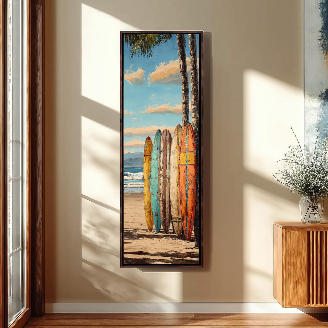 A framed painting depicting a beach scene with surfboards leaning against a palm tree, set against a backdrop of a blue sky with clouds.