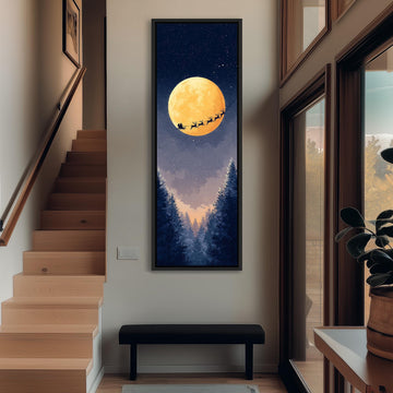 a large, framed painting of Santa Claus and reindeer flying over a snowy landscape with a full moon in the night sky.