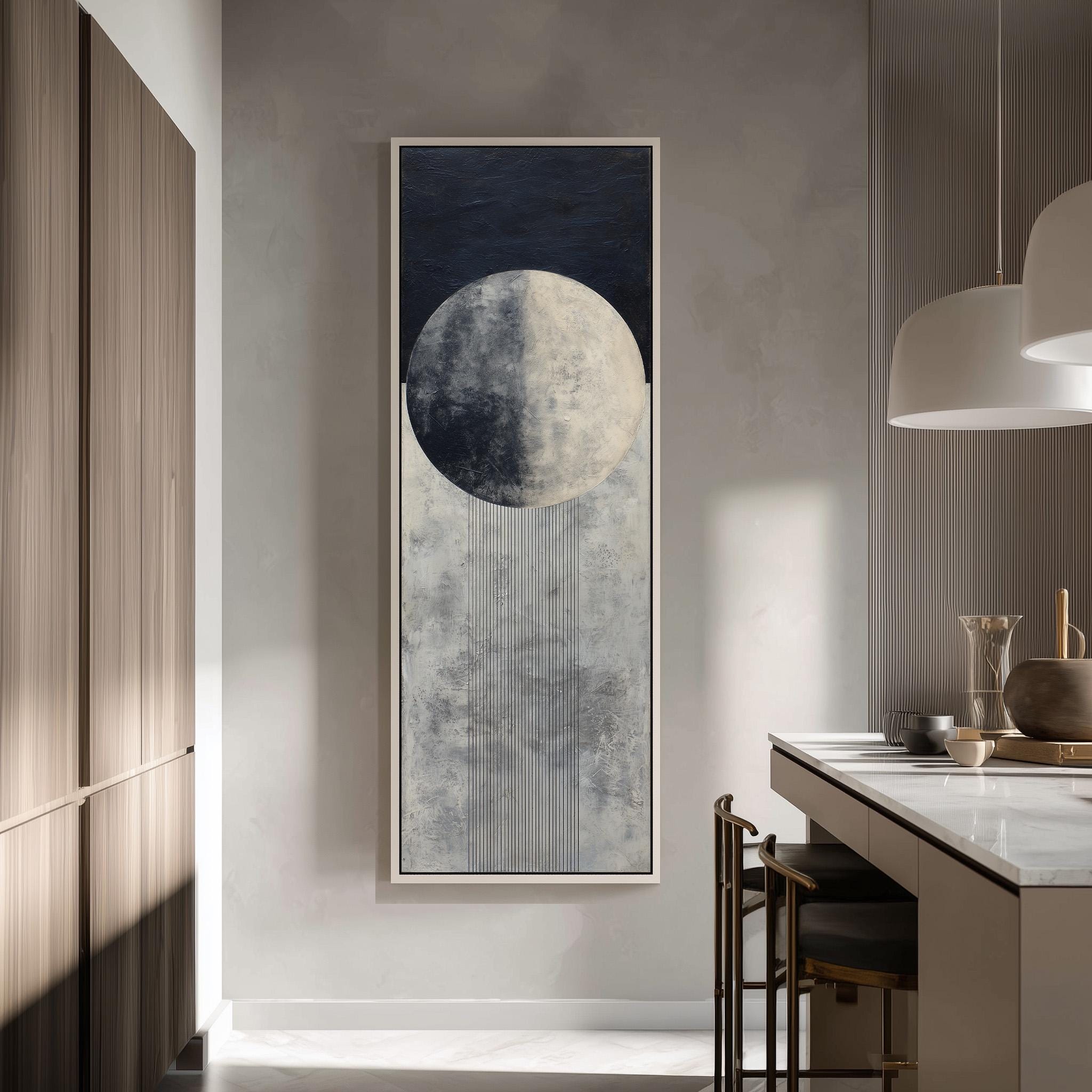 a modern kitchen with a large abstract painting hanging on the wall, depicting a moon and a waterfall. The kitchen has a minimalist design with a white countertop and wooden cabinets.
