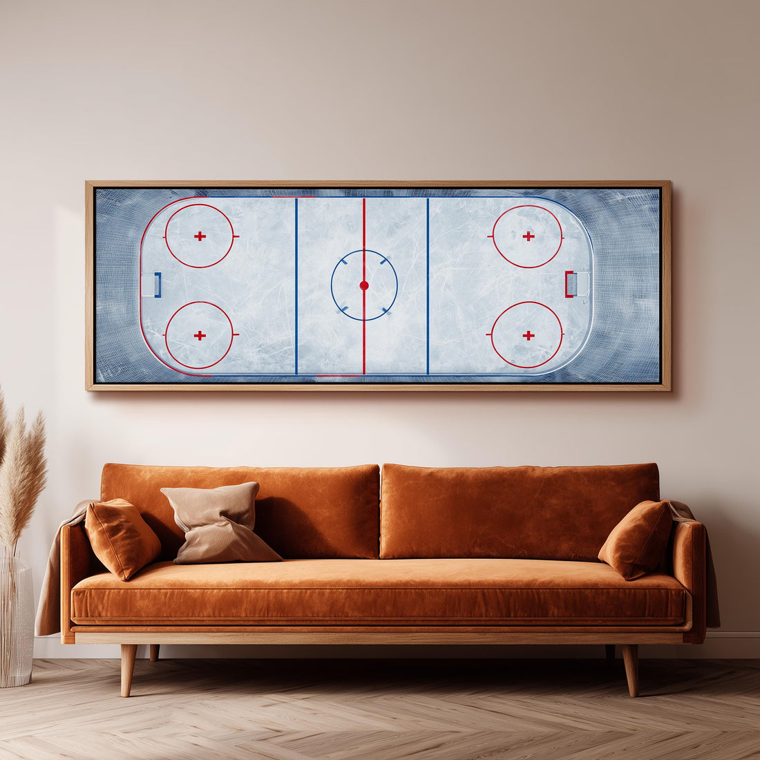 a large framed hockey rink with a blue and white color scheme, mounted on a wall above a white couch with gray and white patterned pillows.