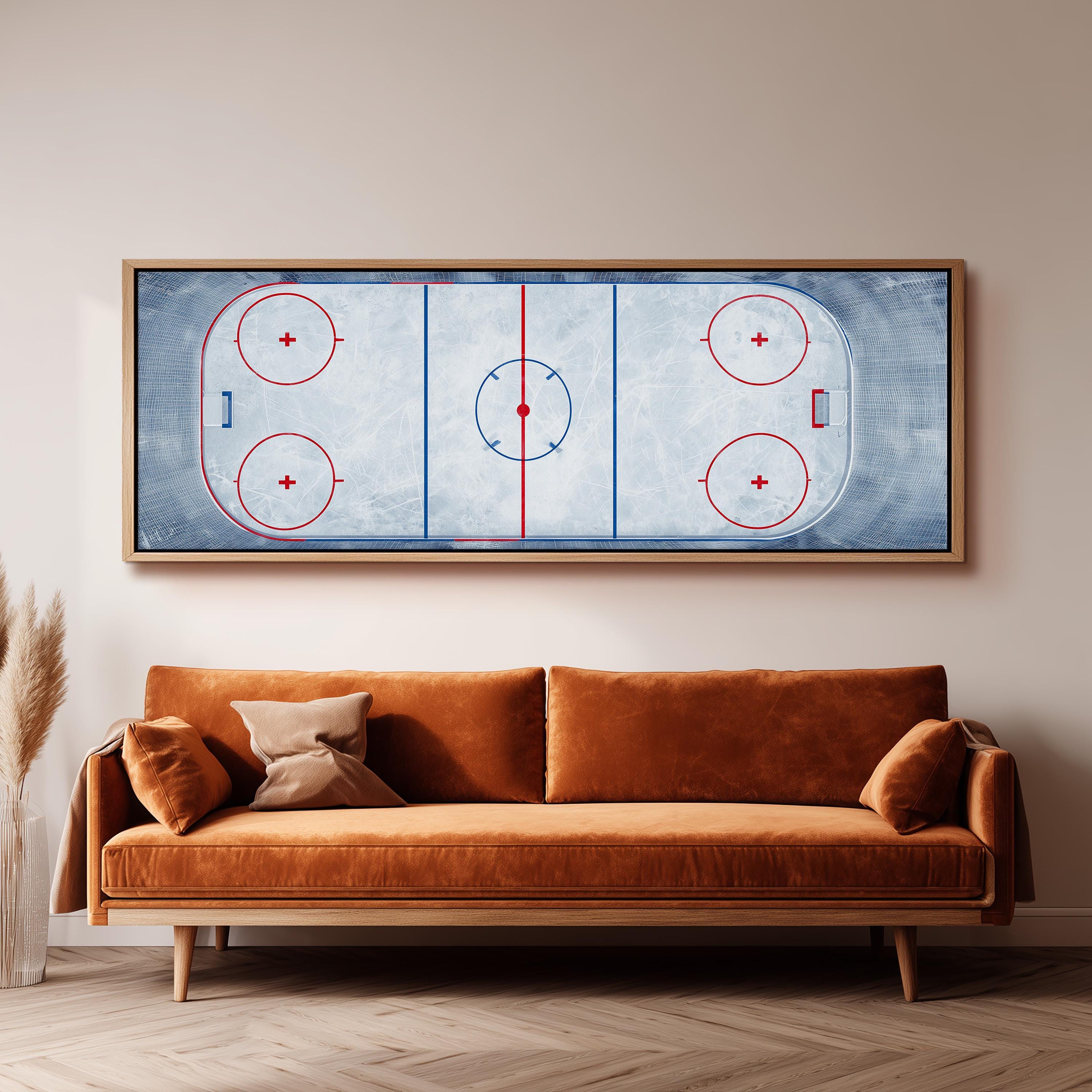 a large framed hockey rink with a red and blue design on the ice, mounted on a wall above a brown sofa.