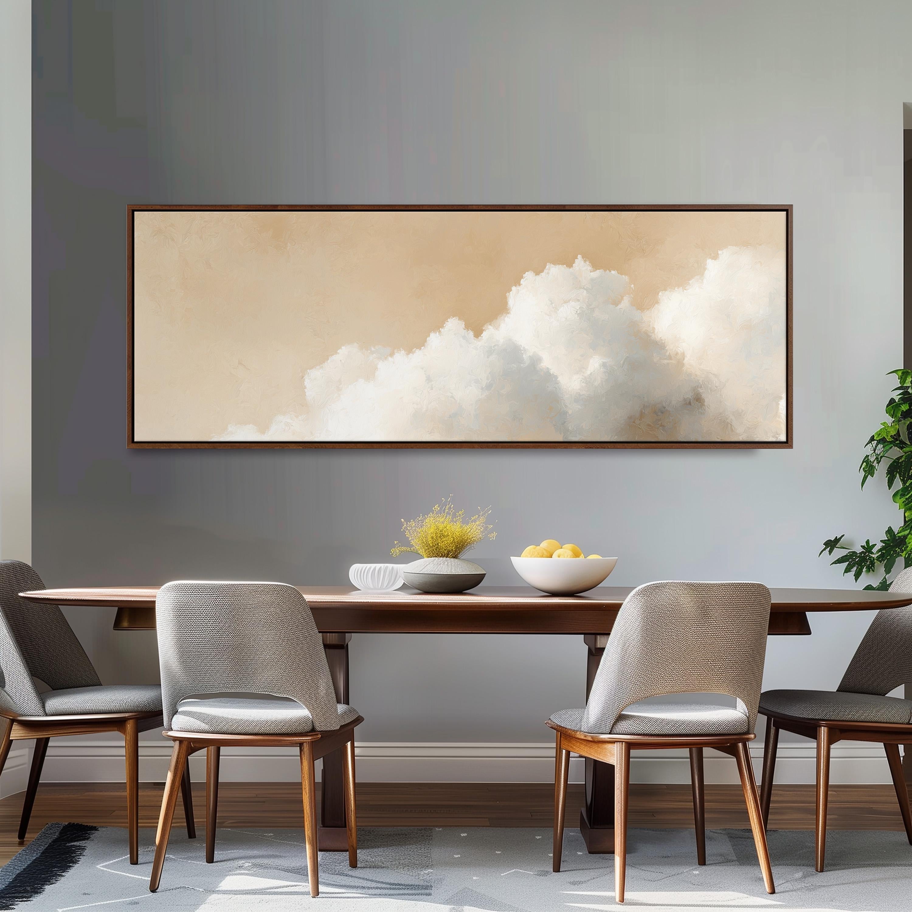 a dining room with a wooden table and four chairs, a large framed painting of clouds hanging above the table, and a bowl of fruit on the table.