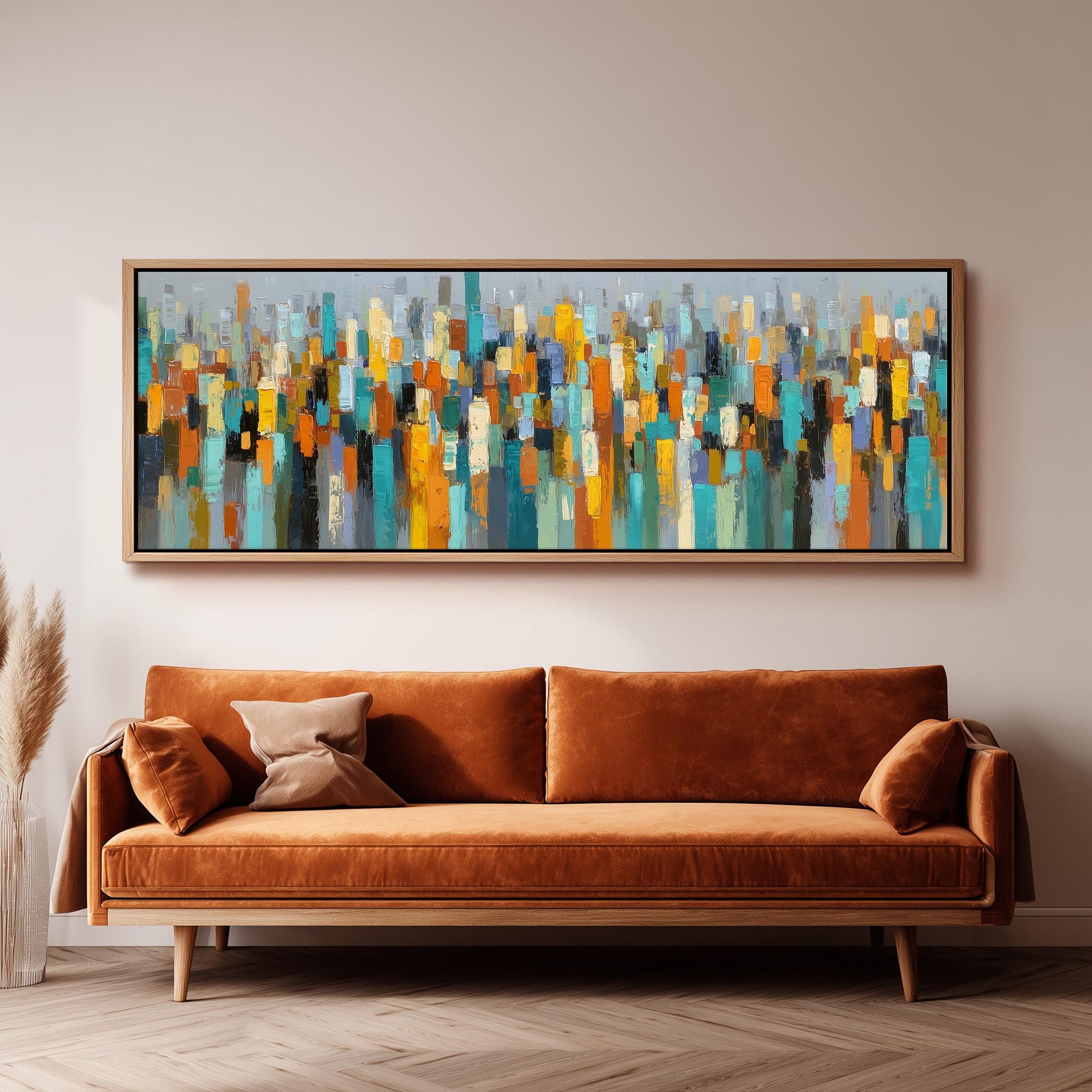 a large abstract painting hanging on a wall above a brown sofa with two pillows.