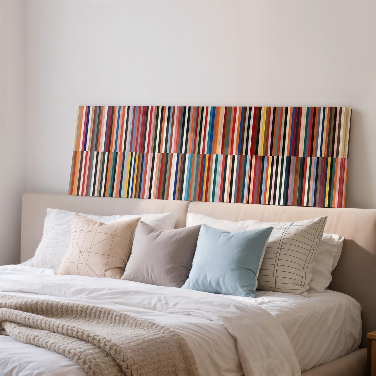 Two bands of colorful stripes wide panoramic canvas print above a bed in a bedroom