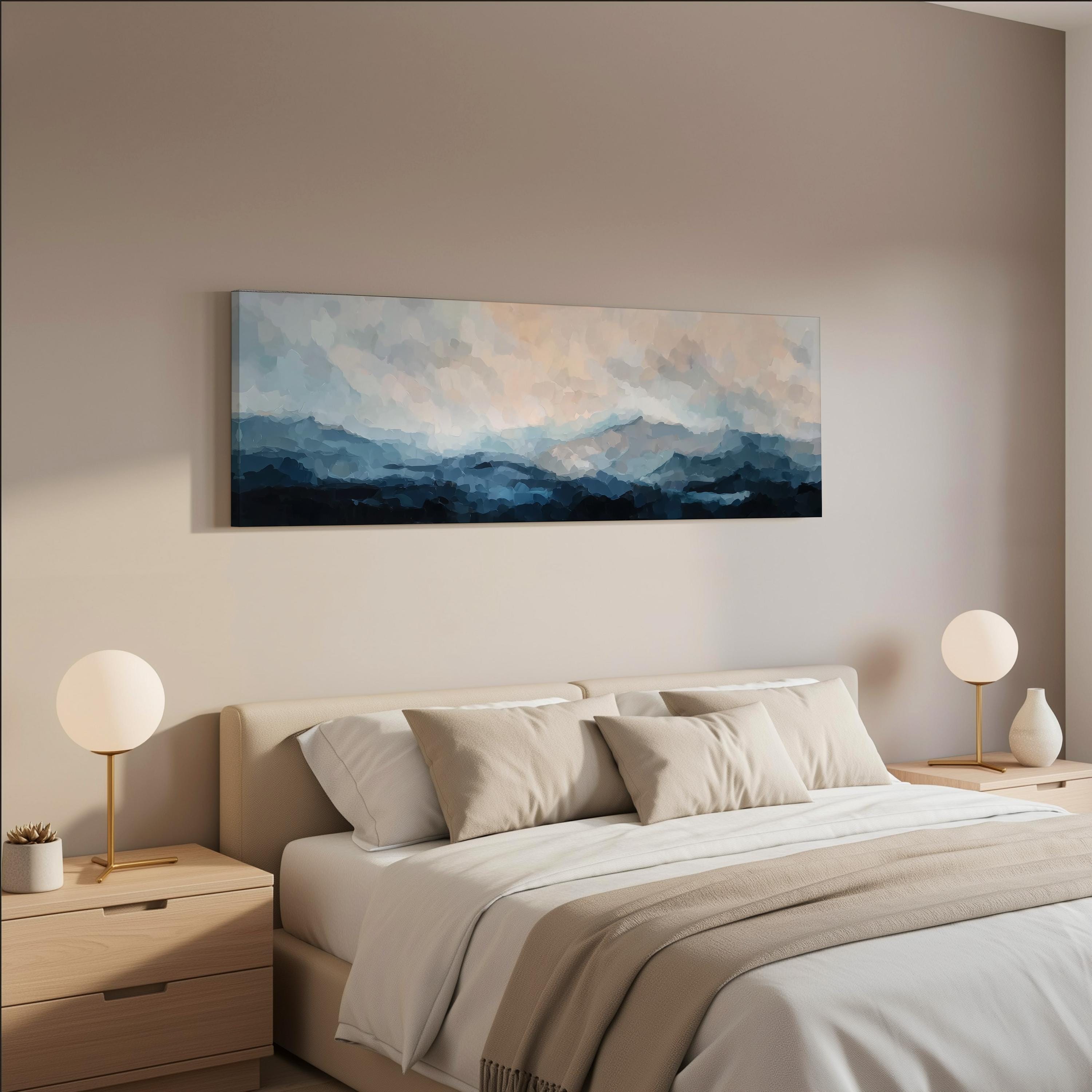 a serene bedroom scene with a large bed adorned with white linens and beige throw pillows. Above the bed, a large painting of a cloudy sky adds a touch of nature to the room. Two white lamps flank the bed, providing a soft, ambient lighting. The overall color scheme of the room is neutral, with the white and beige tones creating a calming and peaceful atmosphere.
