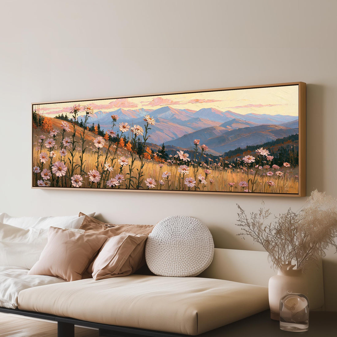 Wildflower meadow with mountains long horizontal canvas print above a sofa in a living room