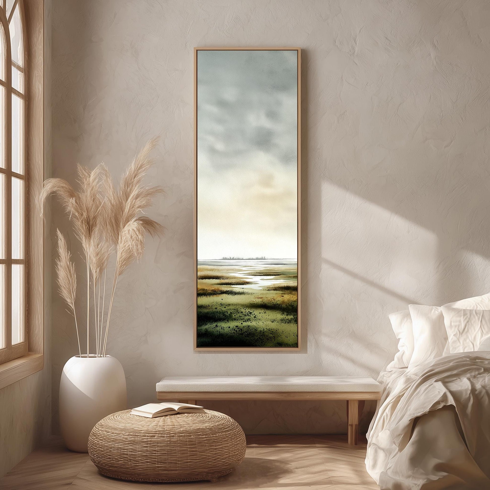 a serene bedroom scene with a large window, a painting of a landscape, a white bench, a woven ottoman, and a potted plant.