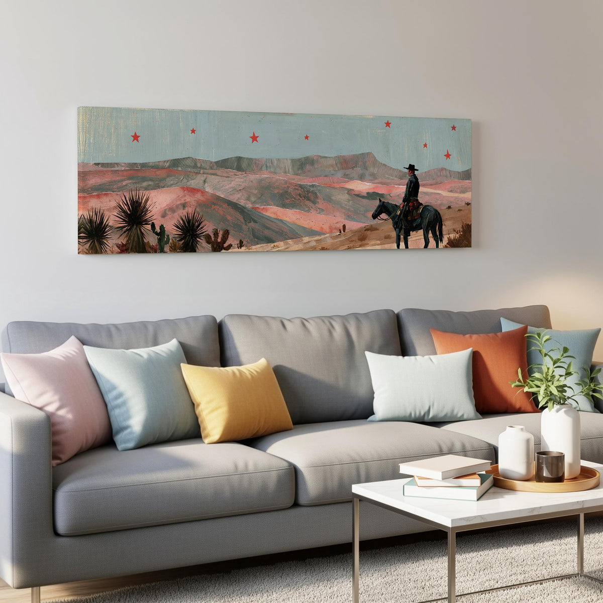 Desert cowboy under red stars panoramic canvas print above a grey sofa in a living room