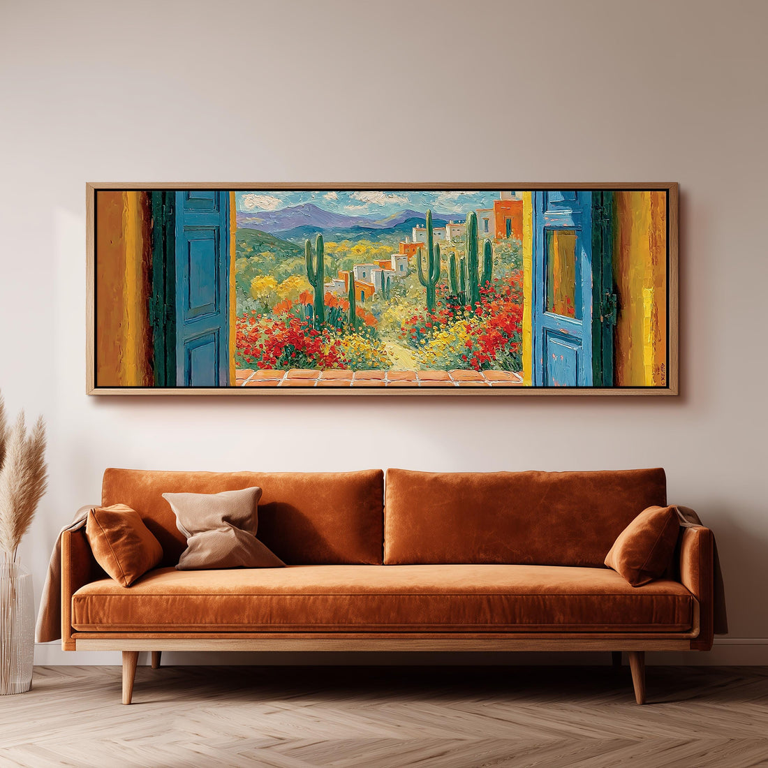 Cactus courtyard seen through blue doors long horizontal canvas print above a sofa in a living room