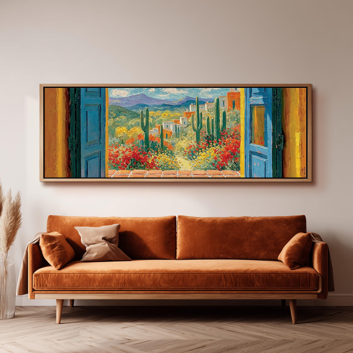 Cactus courtyard seen through blue doors long horizontal canvas print above a sofa in a living room
