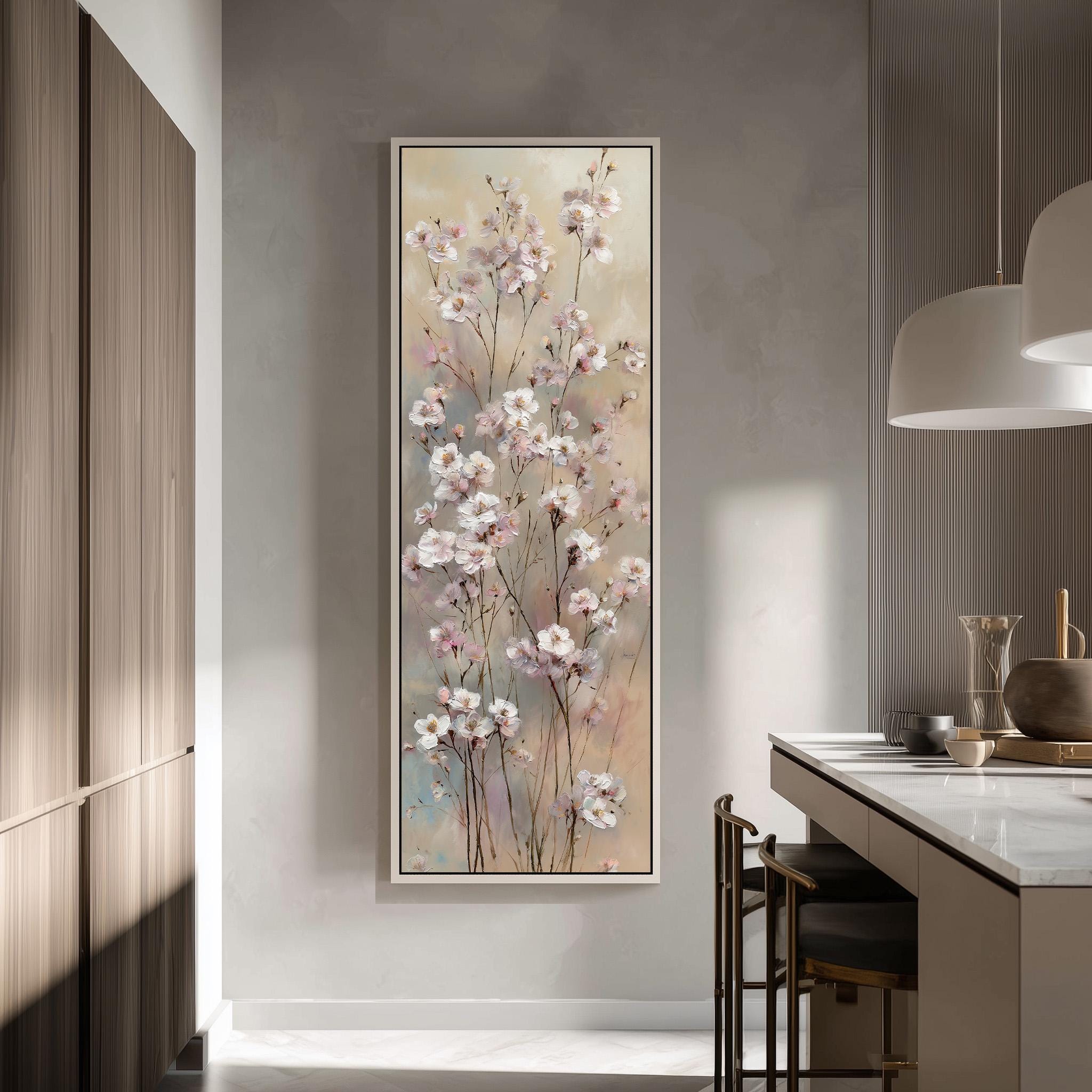 a large framed painting of pink flowers hanging on a wall in a modern kitchen.
