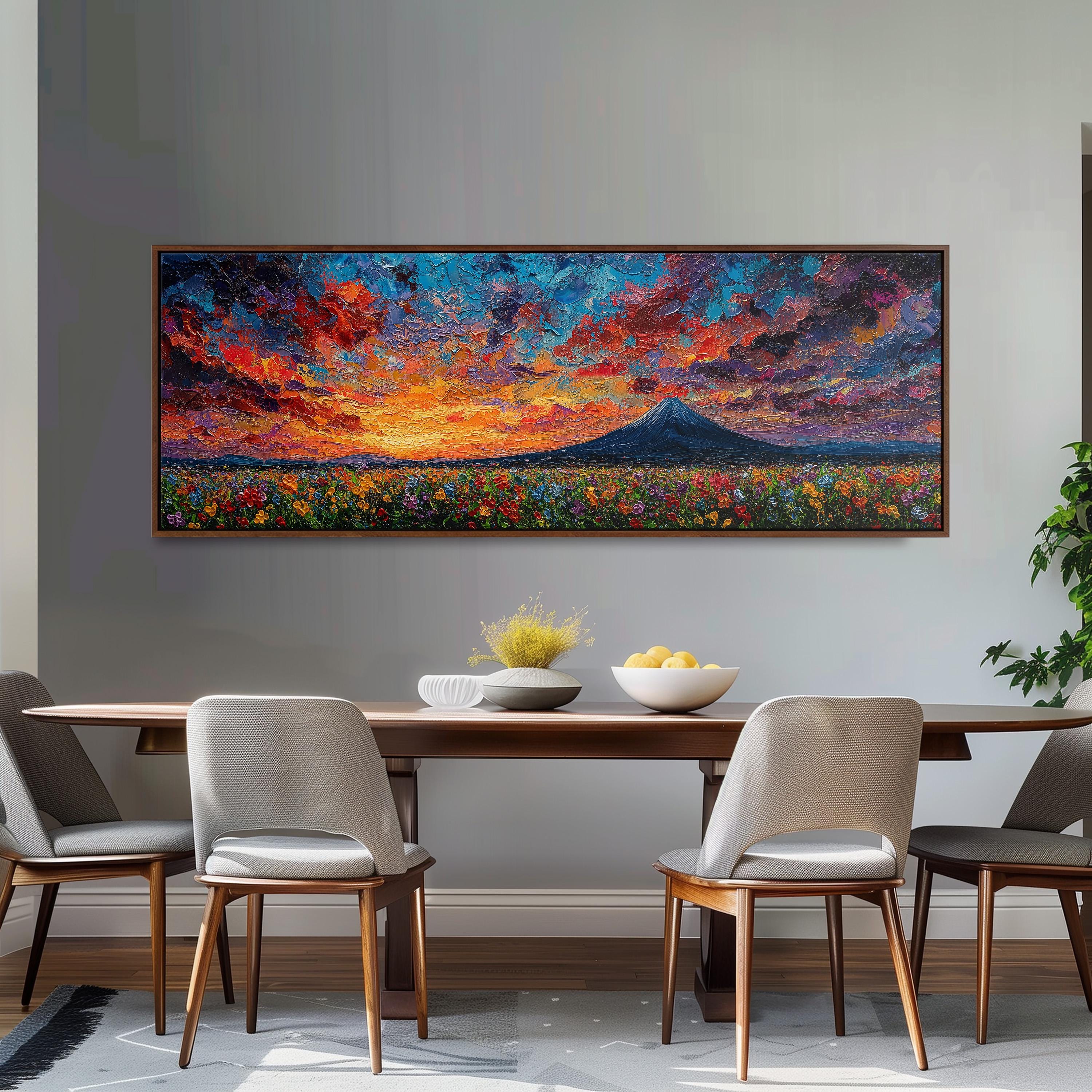 a large, colorful painting of a sunset over a field of flowers hanging on a wall above a wooden dining table with four chairs.