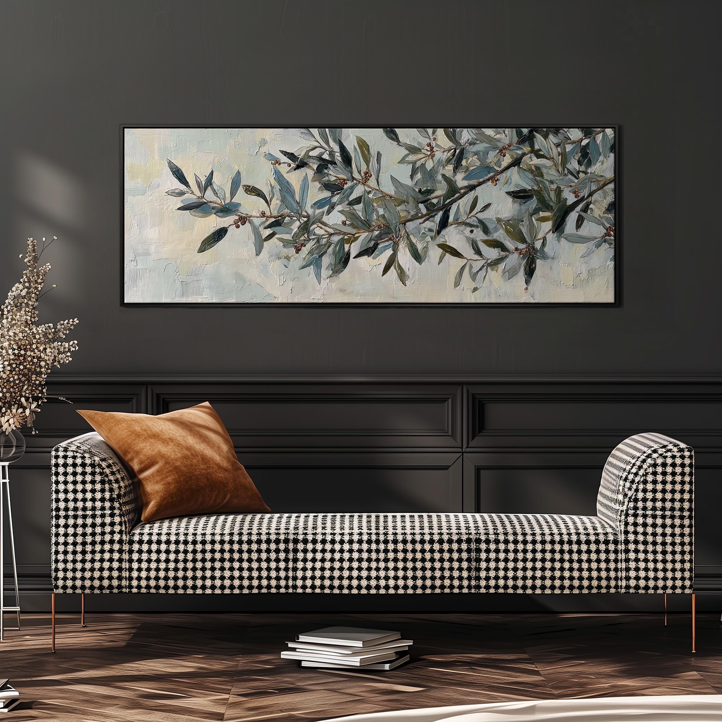a black and white checkered sofa with a brown throw pillow, set against a dark wall with a large painting of a branch with green leaves and branches hanging above it.