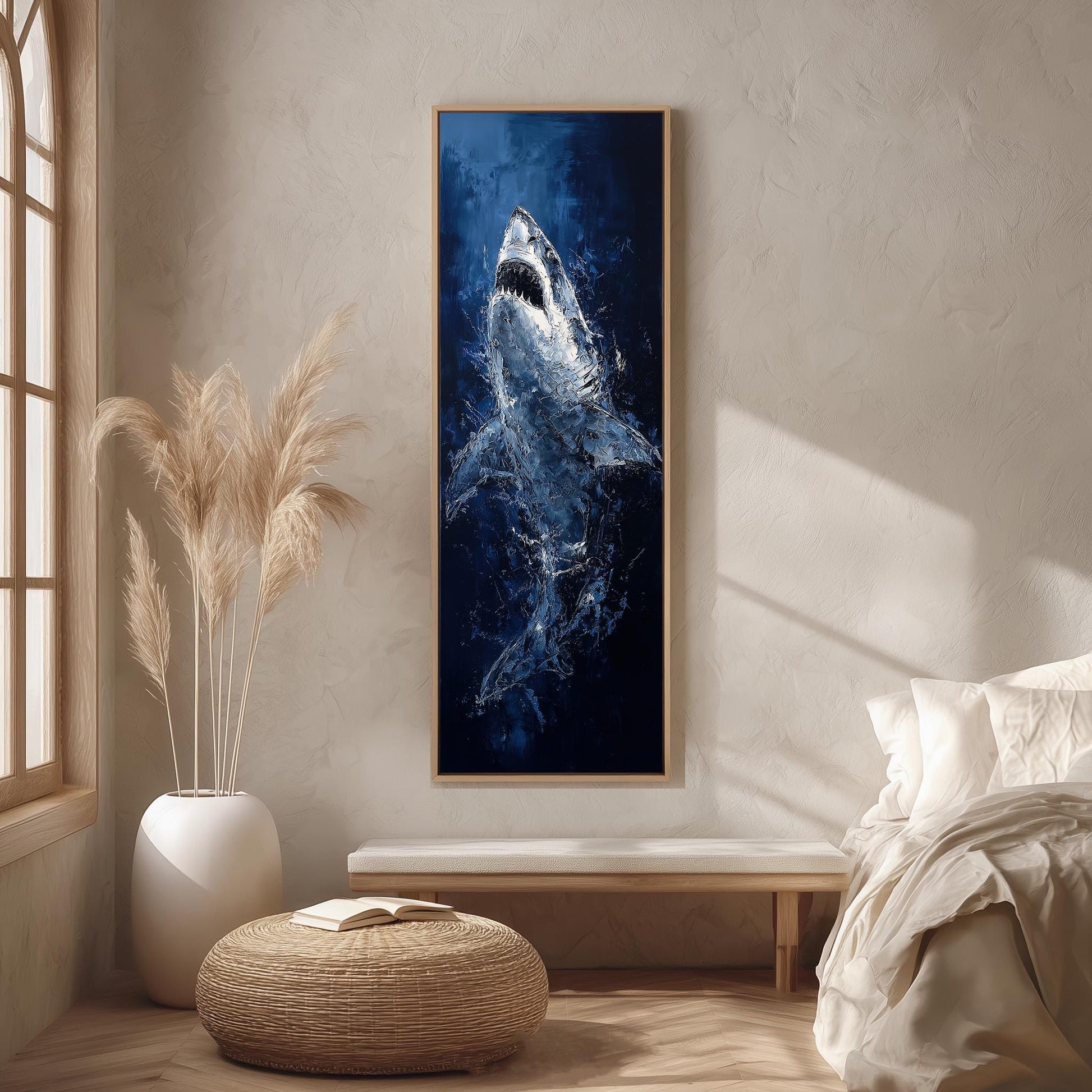 a large framed painting of a shark hanging on a wall in a room with a bed, a potted plant, and a woven ottoman.