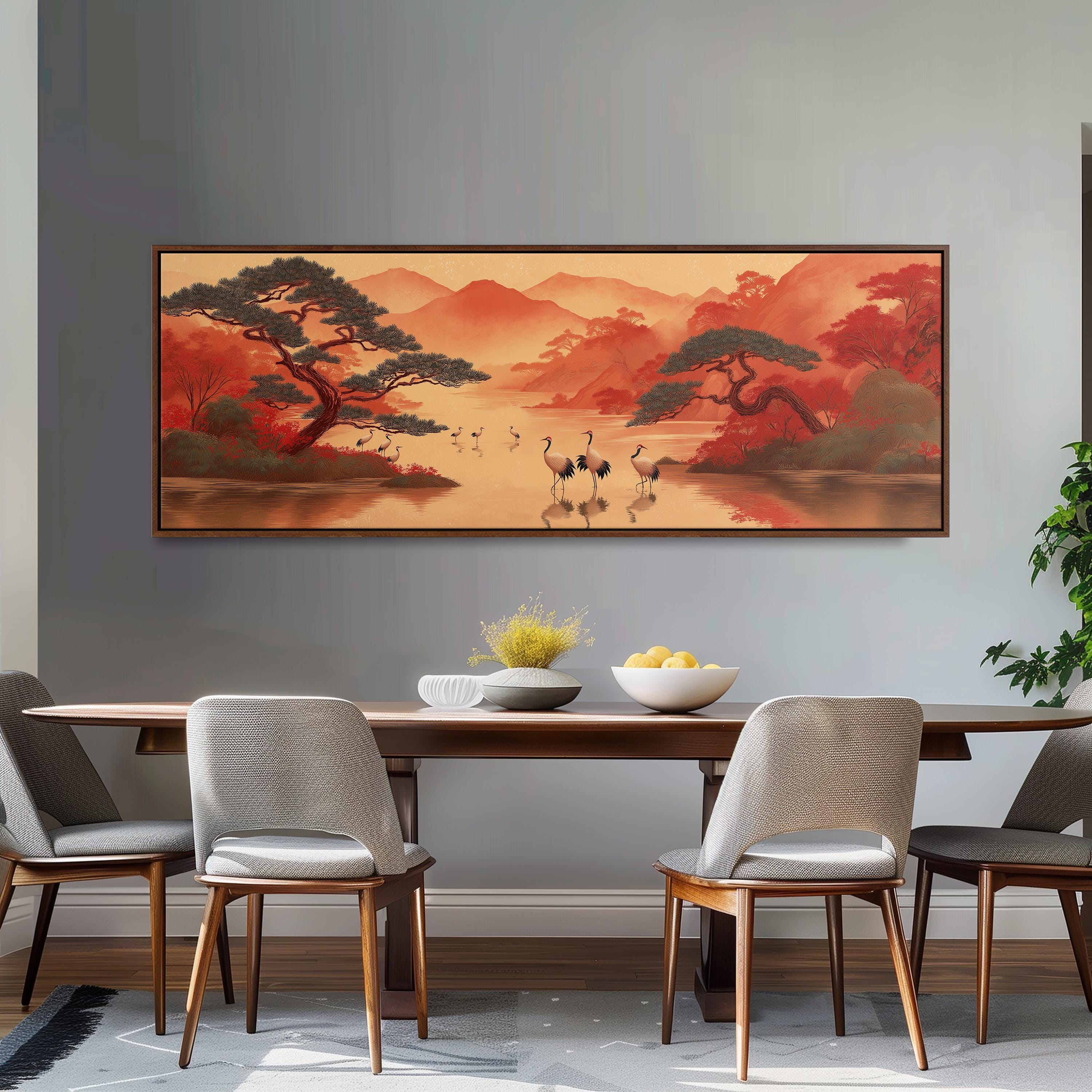 a dining room with a large painting of a serene landscape hanging on the wall above a wooden dining table with four chairs. The painting depicts a tranquil scene of cranes walking along a river, surrounded by mountains and trees.