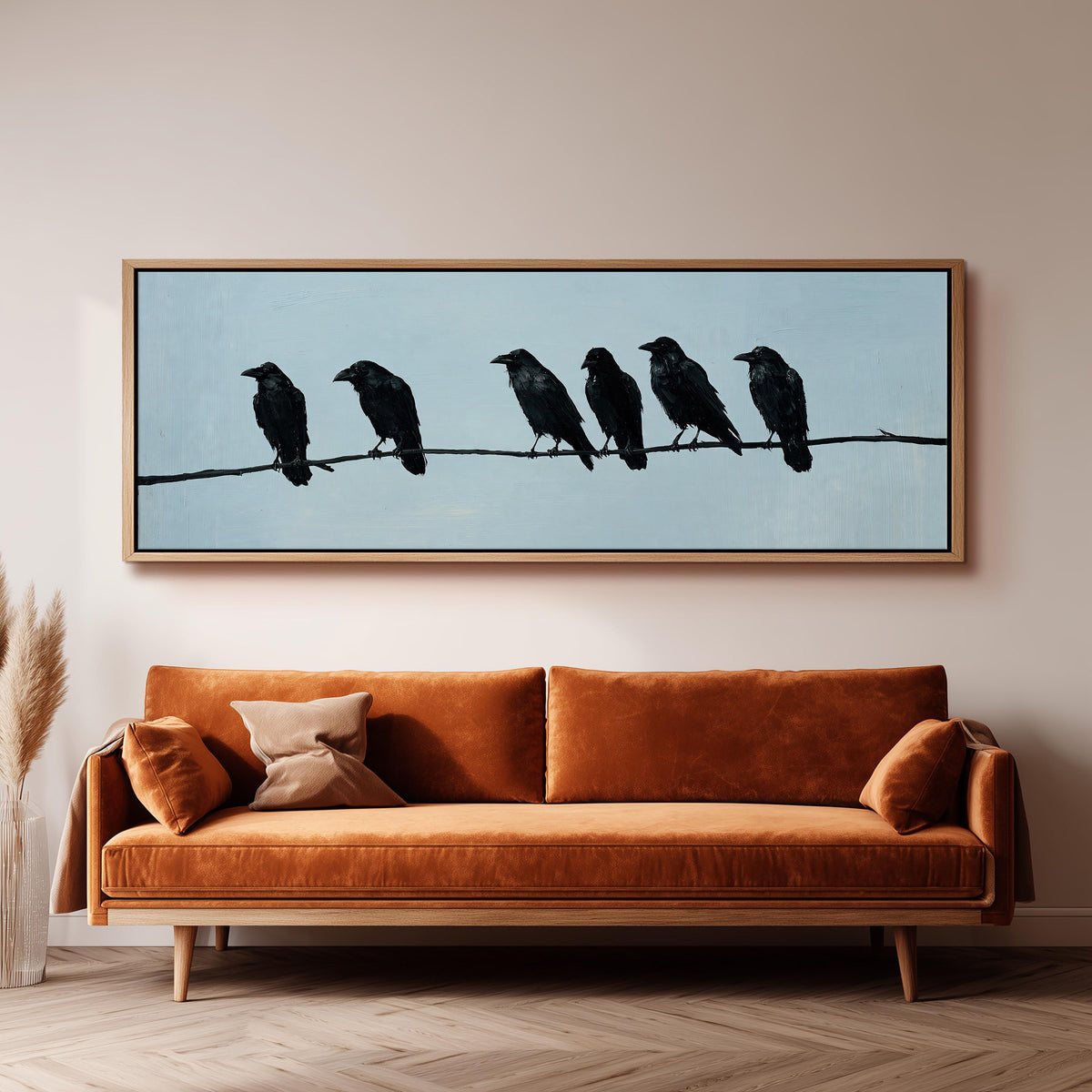 Ravens spaced along a wire wide panoramic canvas print above a bench in a dark living room