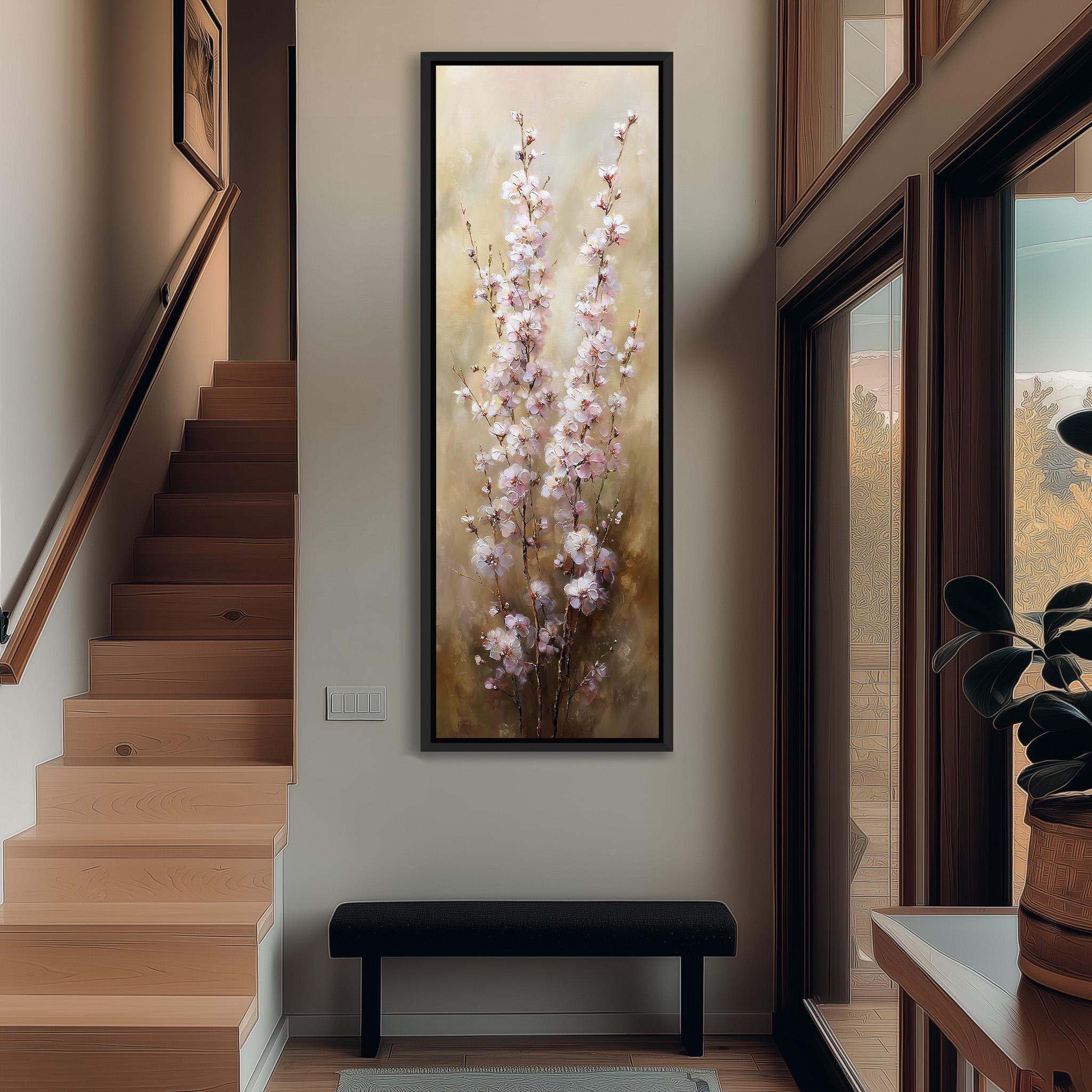 a large painting of pink flowers hanging on the wall of a hallway. The painting is framed and appears to be the focal point of the space. The hallway has a wooden staircase and a bench, creating a cozy and inviting atmosphere.