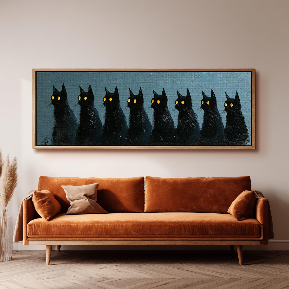 Row of black cats with glowing eyes panoramic canvas print above a sofa in a living room