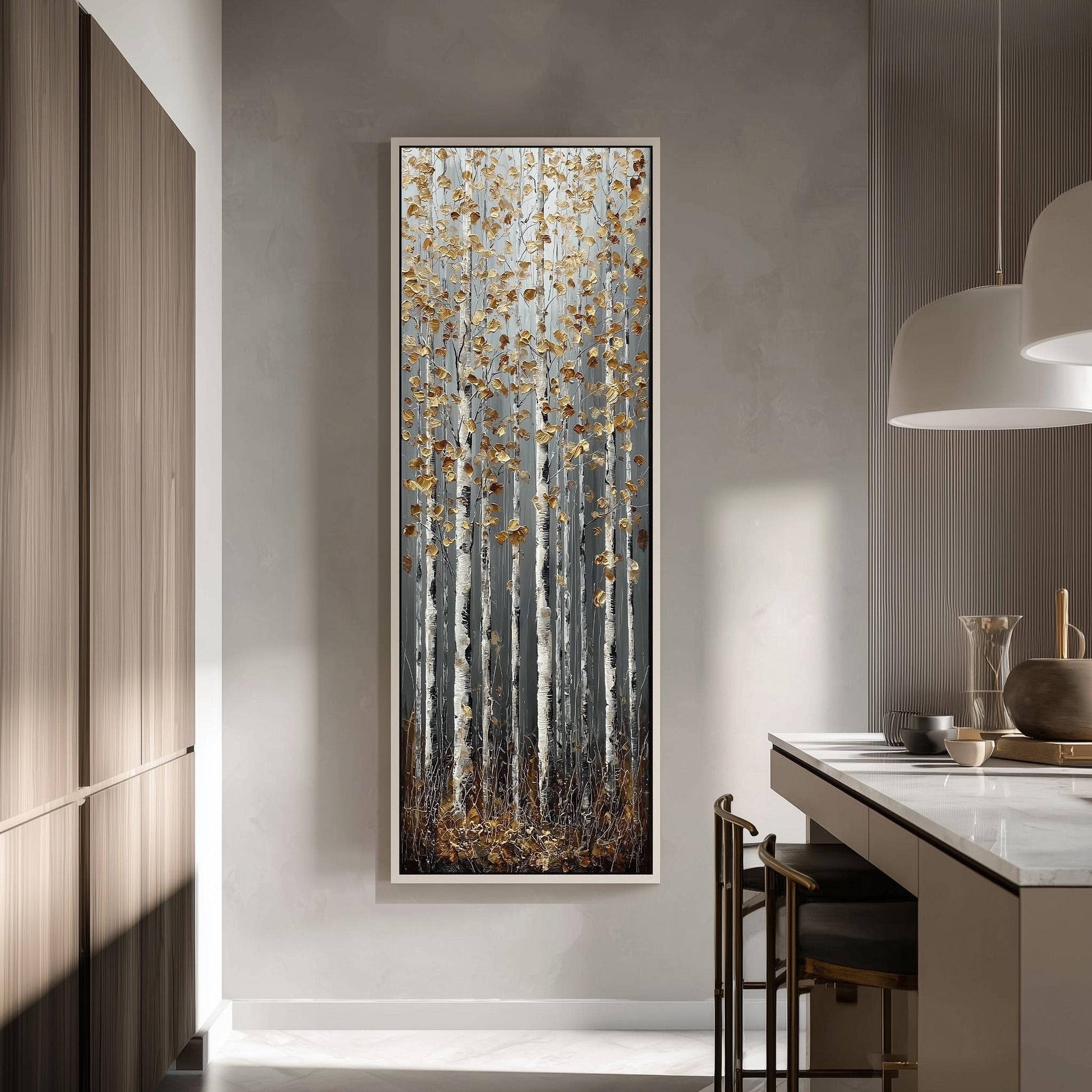 a large, framed painting of a forest scene with tall trees and golden leaves hanging from them, hanging on a wall in a modern kitchen.