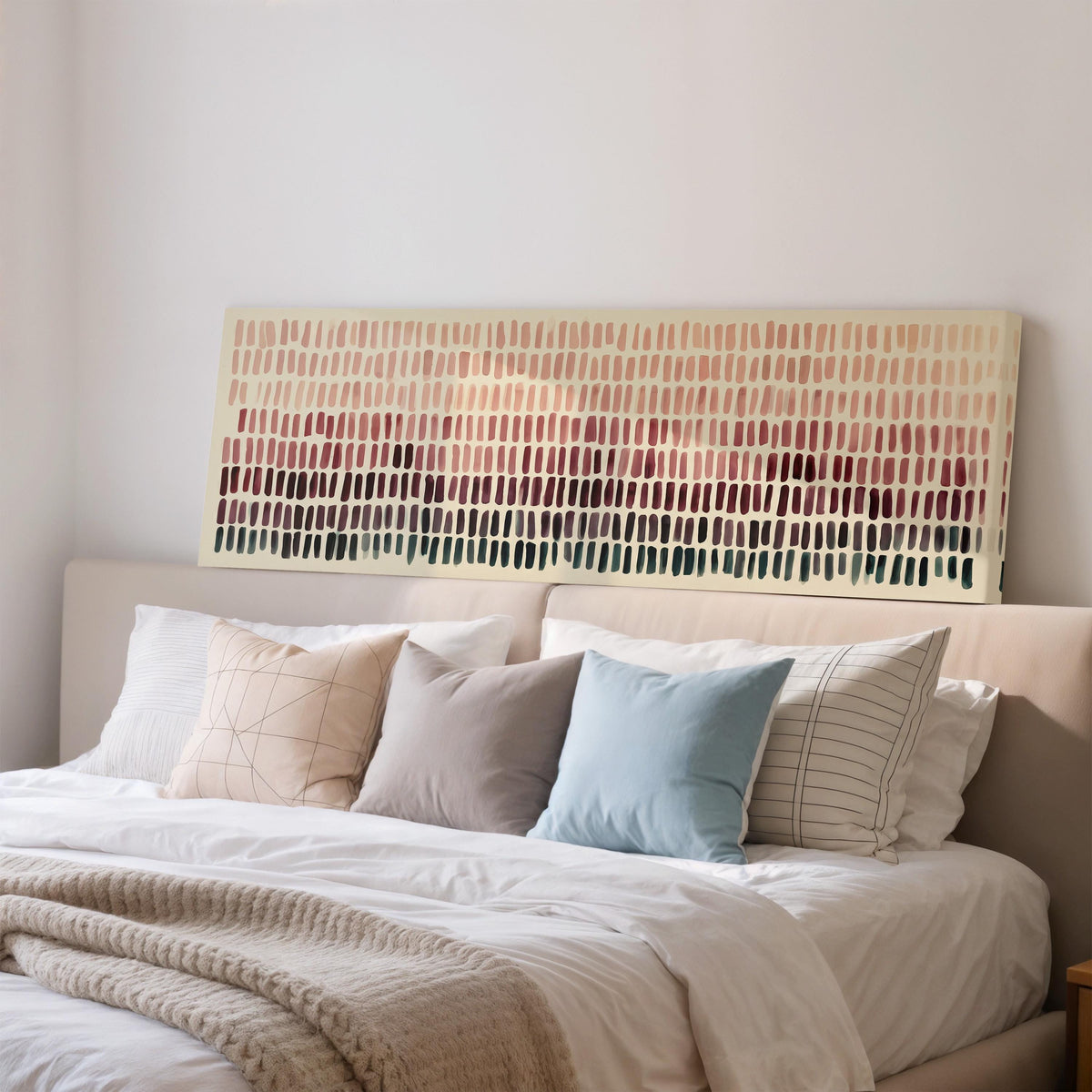 Brushmarks fading from blush to deep maroon wide panoramic canvas print above a bed in a bedroom