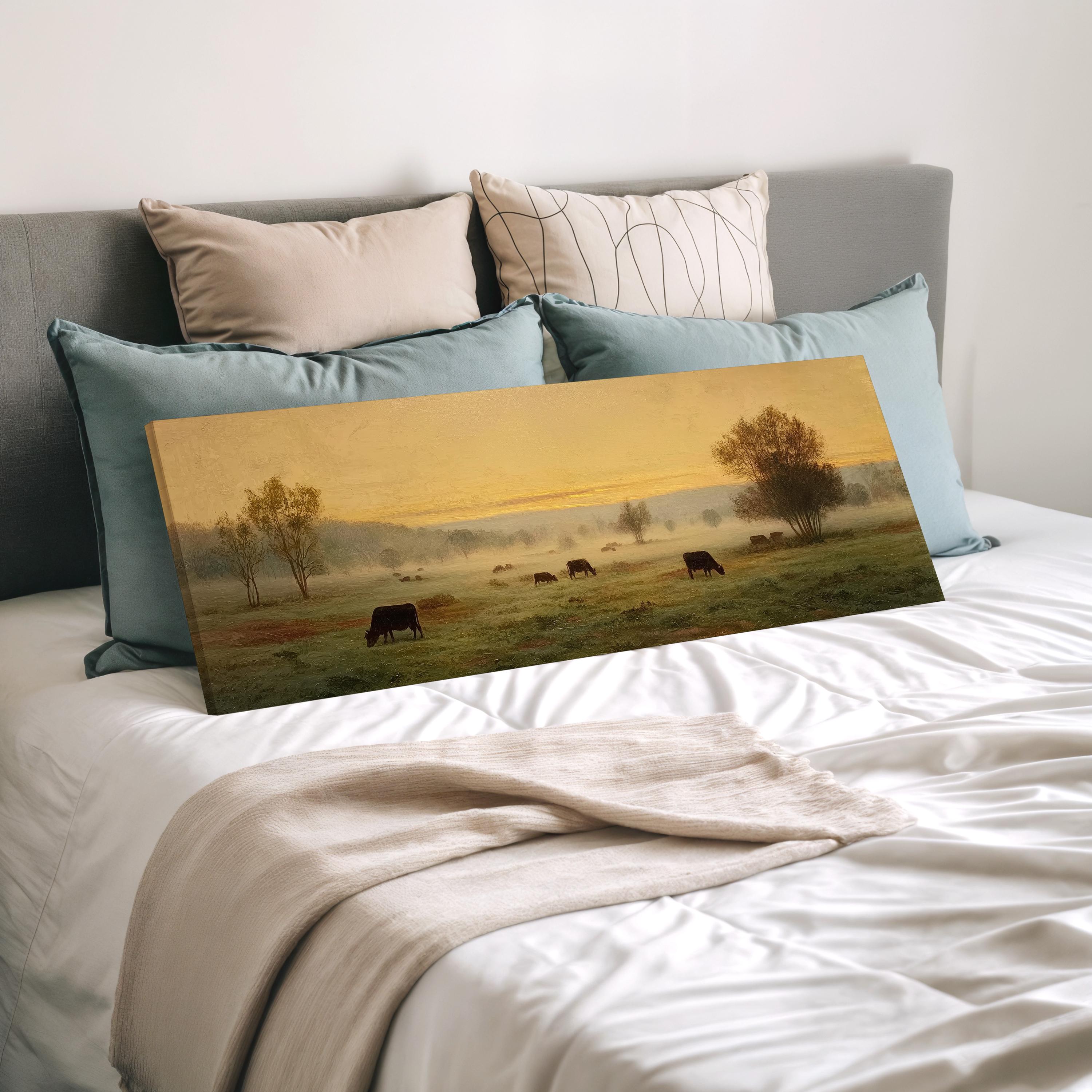 a pastoral scene with cows grazing in a field, set against a hazy, golden-hued sky.