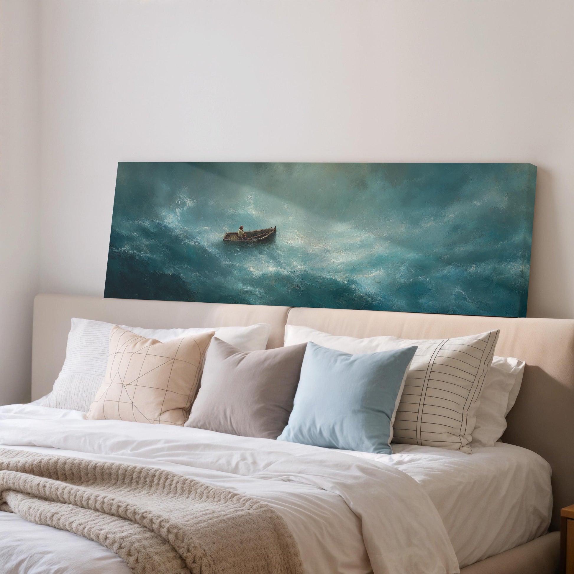 a large painting of a boat on a stormy sea hanging on a wall above a bed with white pillows and a gray blanket.