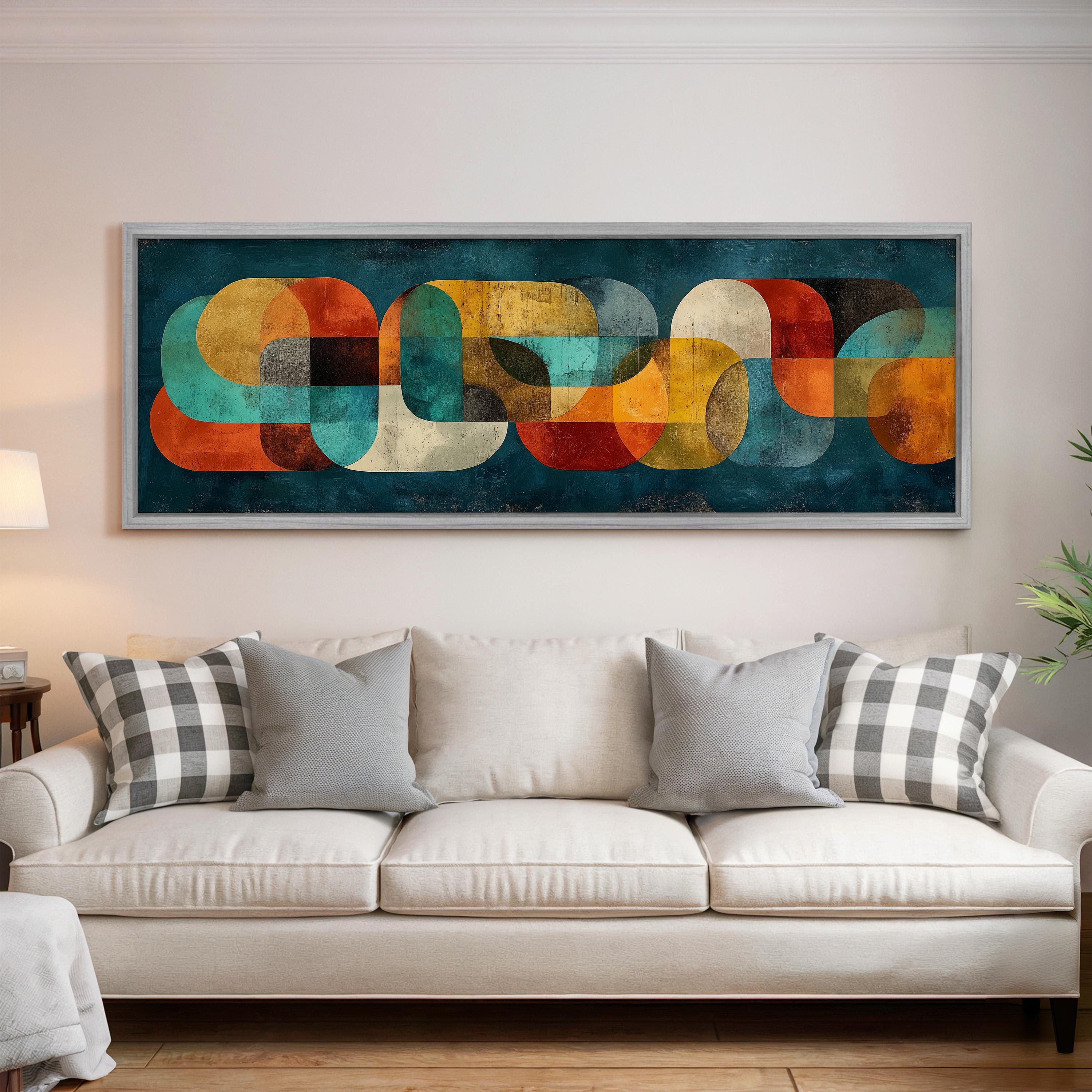 a large abstract painting hanging on a wall above a white couch with gray and black plaid throw pillows.