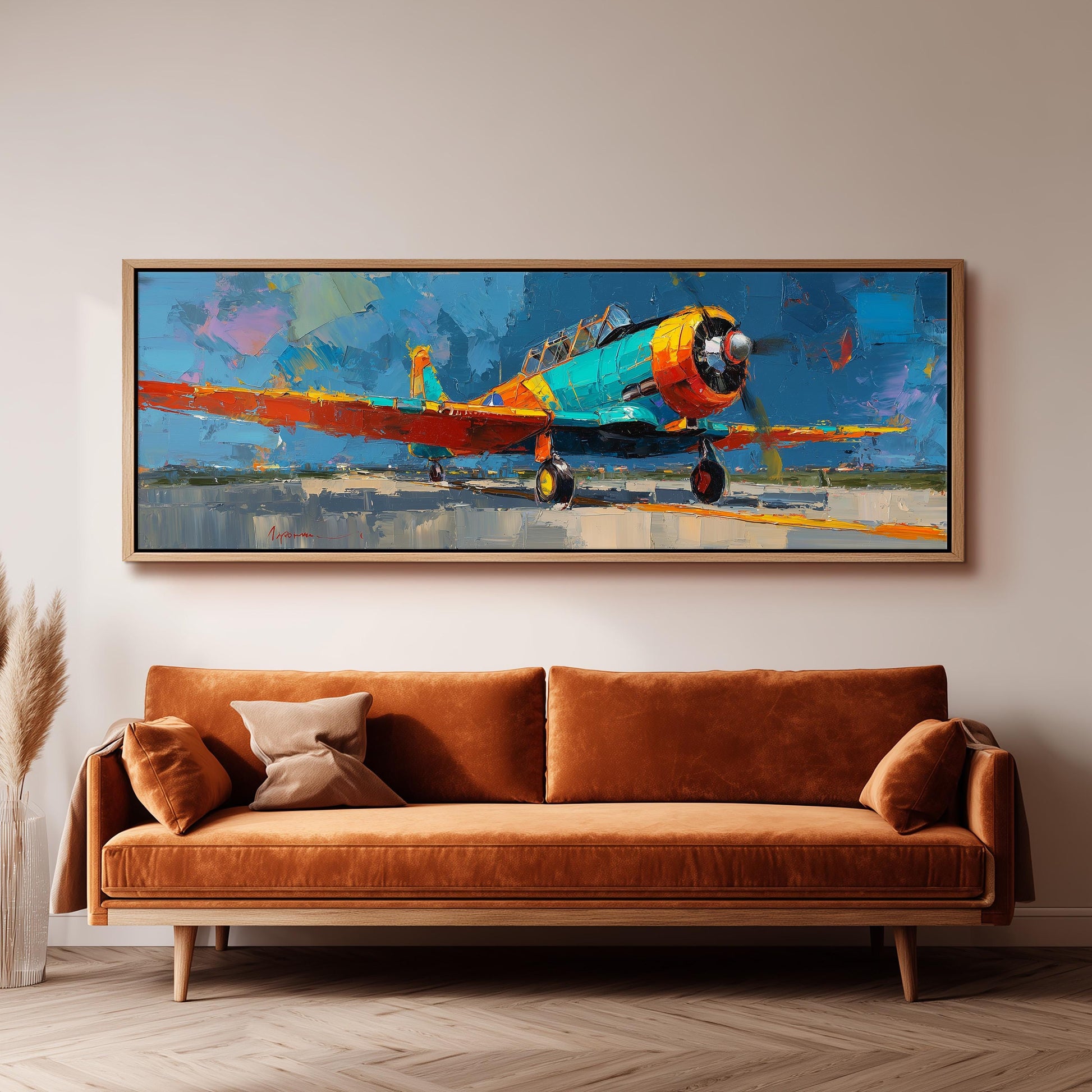 a large, colorful painting of a propeller plane hanging on a wall above a brown sofa.