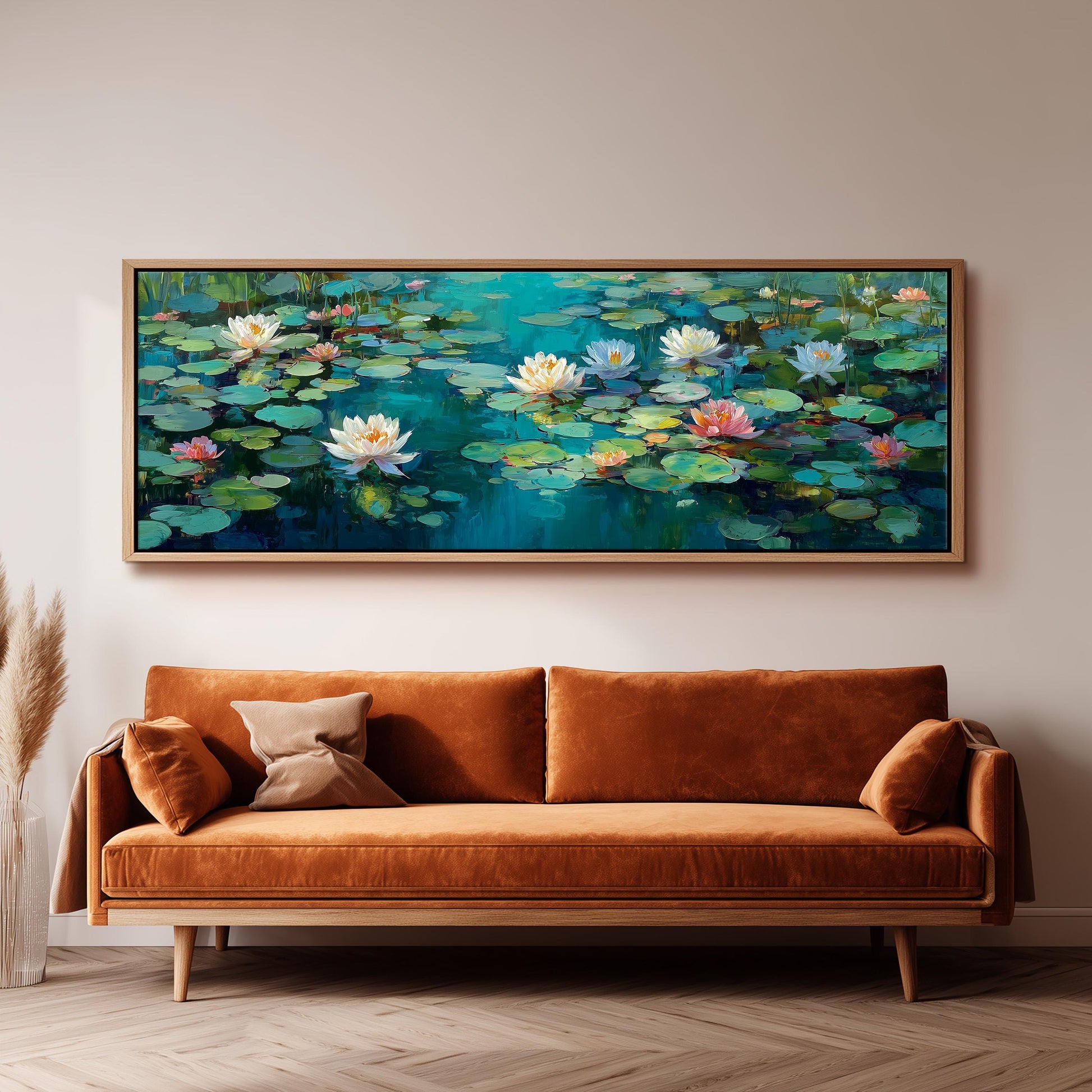 a large painting of lily pads hanging on a wall above a brown sofa.