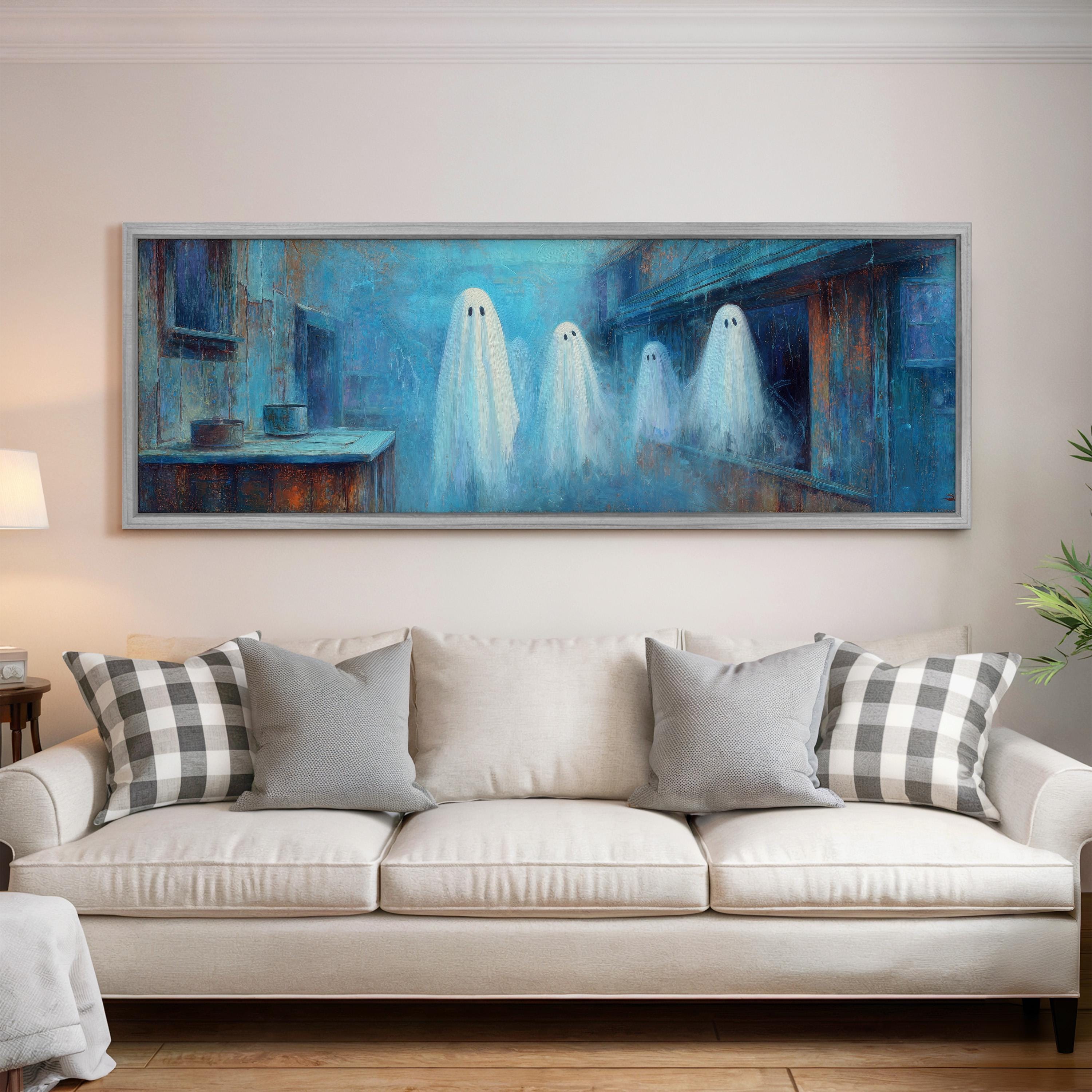 a large painting of three ghostly figures floating in a blue and white color scheme, hanging on a wall above a white couch with gray and white patterned throw pillows.