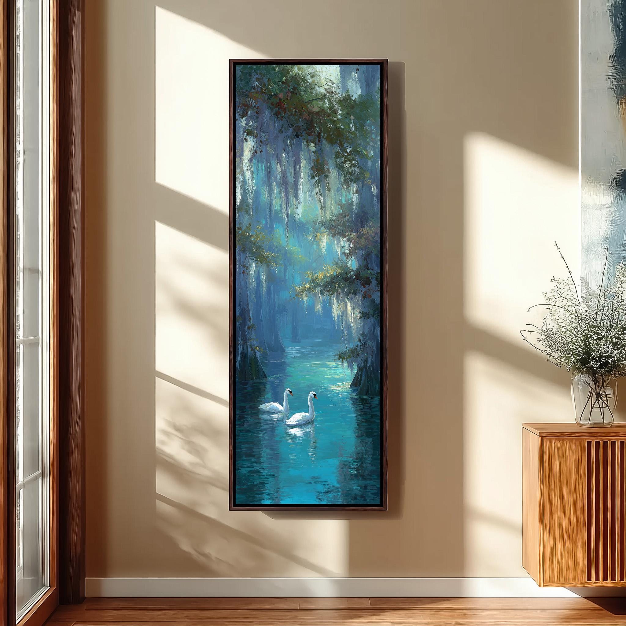 a large painting of two swans swimming in a blue-green body of water, hanging on a wall in a room with a wooden floor and a window.