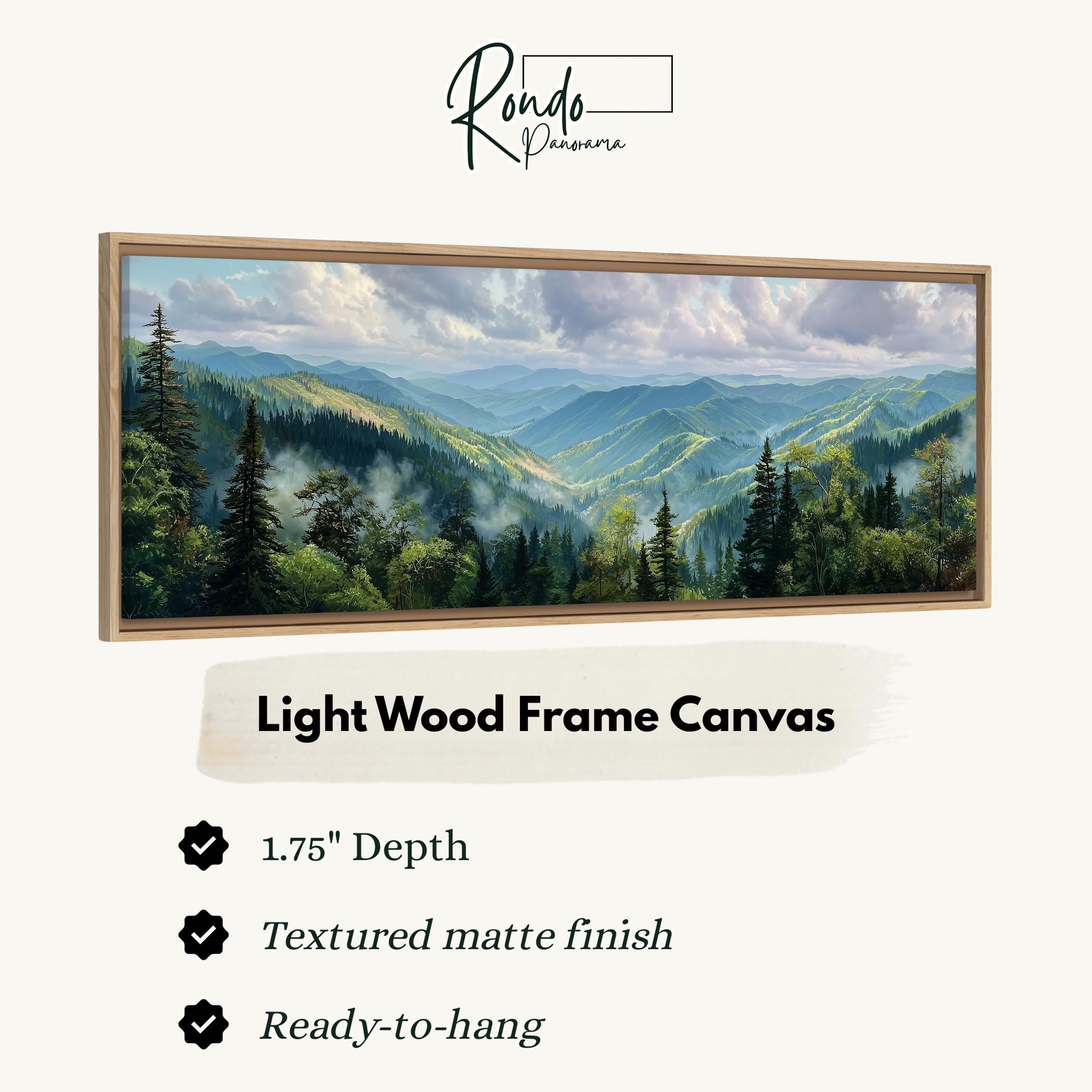 The image is a framed landscape painting depicting a mountainous, forested area with a cloudy sky.