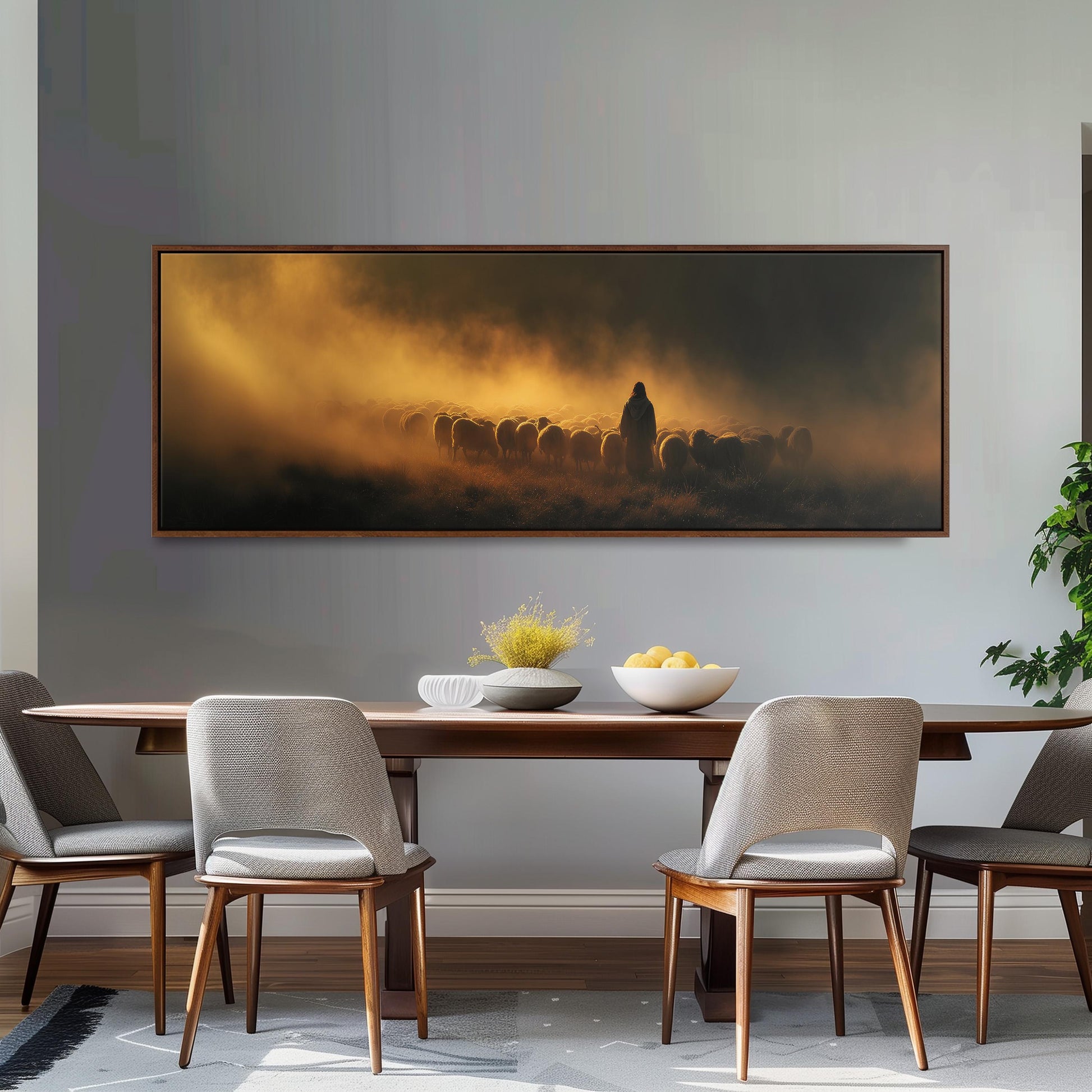 a dining room with a large painting of a herd of animals on the wall above a wooden dining table with four chairs. The painting is hanging above a bowl of fruit and a vase of flowers, creating a warm and inviting atmosphere.