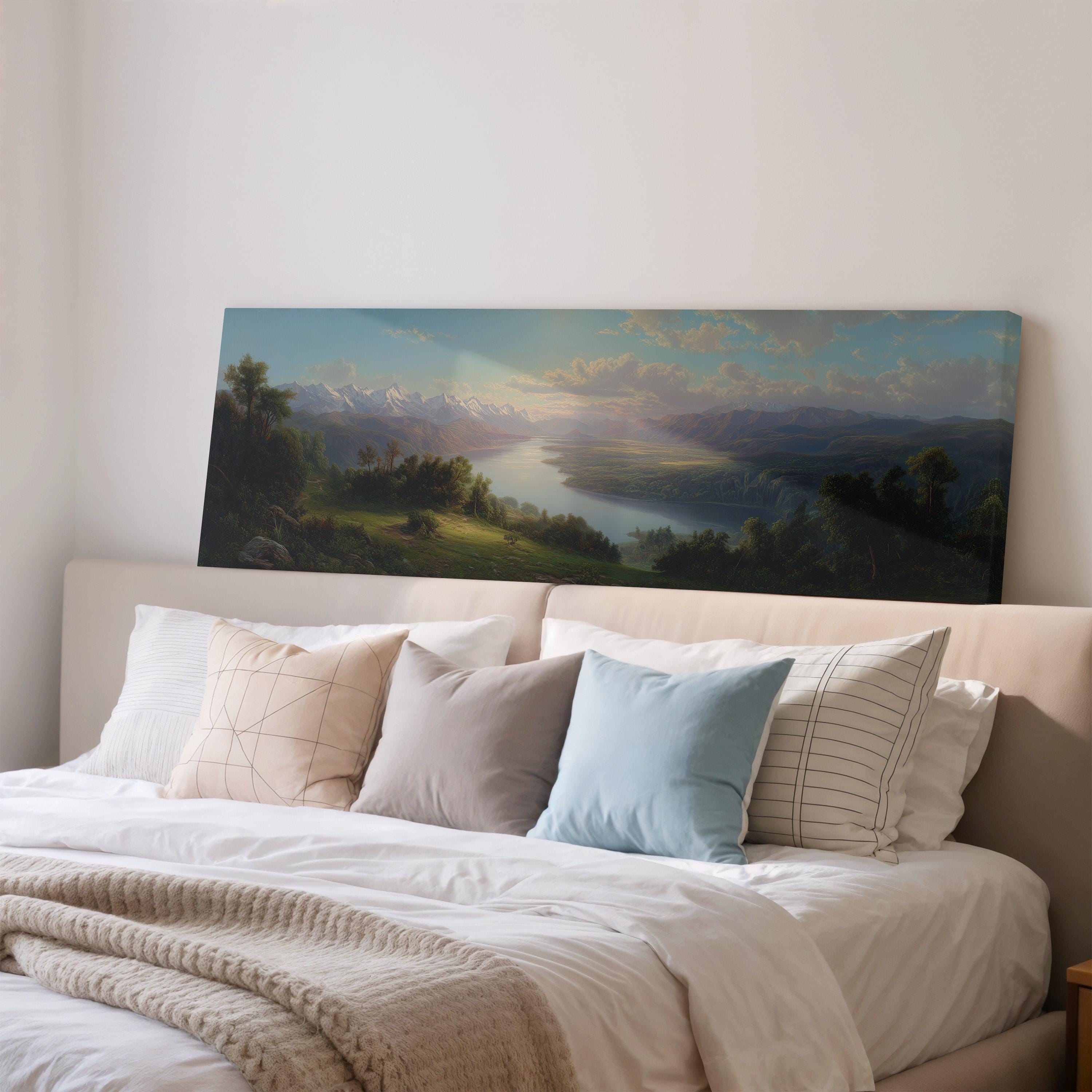 a large landscape painting hanging on a wall above a bed with white bedding and pillows.