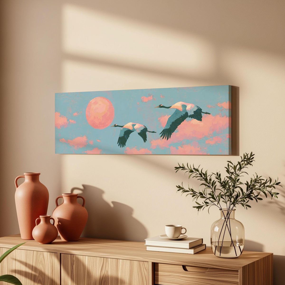 Two cranes flying at sunset long horizontal canvas print above a wooden sideboard